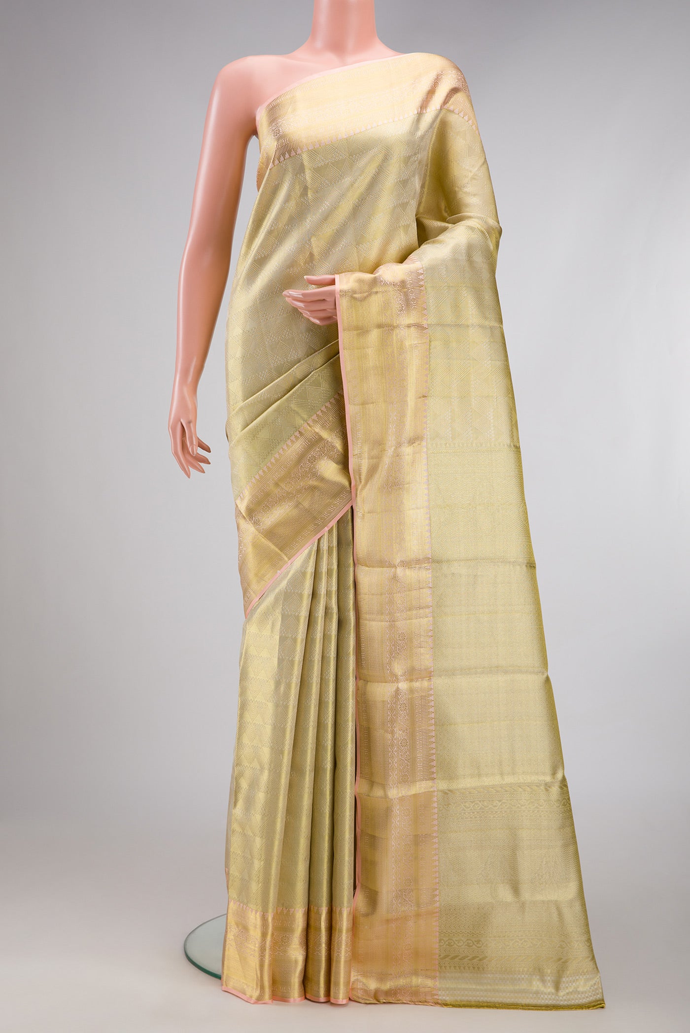 Gold Dual Tone Kanchipuram Tissue Silk Saree with Zari Brocade on the body and Zari Border.  displayed on a mannequin