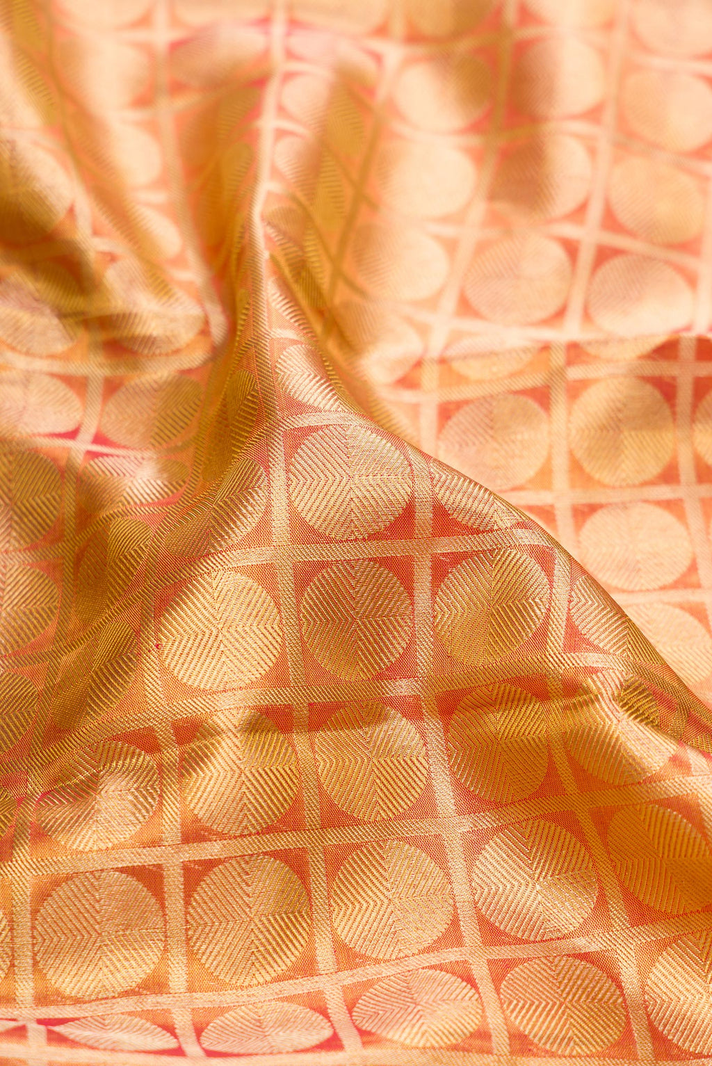Close up of Gold Dual Tone Kanchipuram Tissue Silk Saree with Zari Brocade on the body and Zari Border.  displaying folds