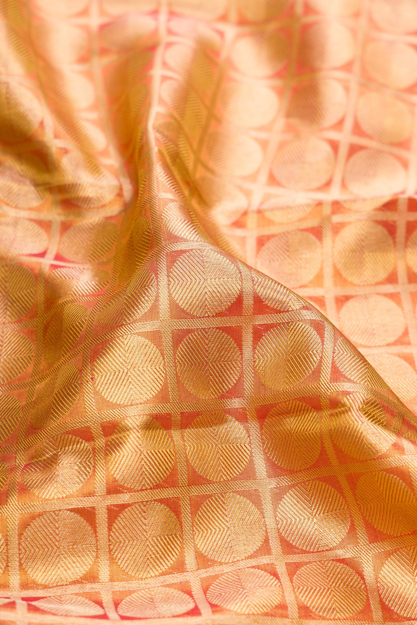 Close up of Gold Dual Tone Kanchipuram Tissue Silk Saree with Zari Brocade on the body and Zari Border.  displaying folds