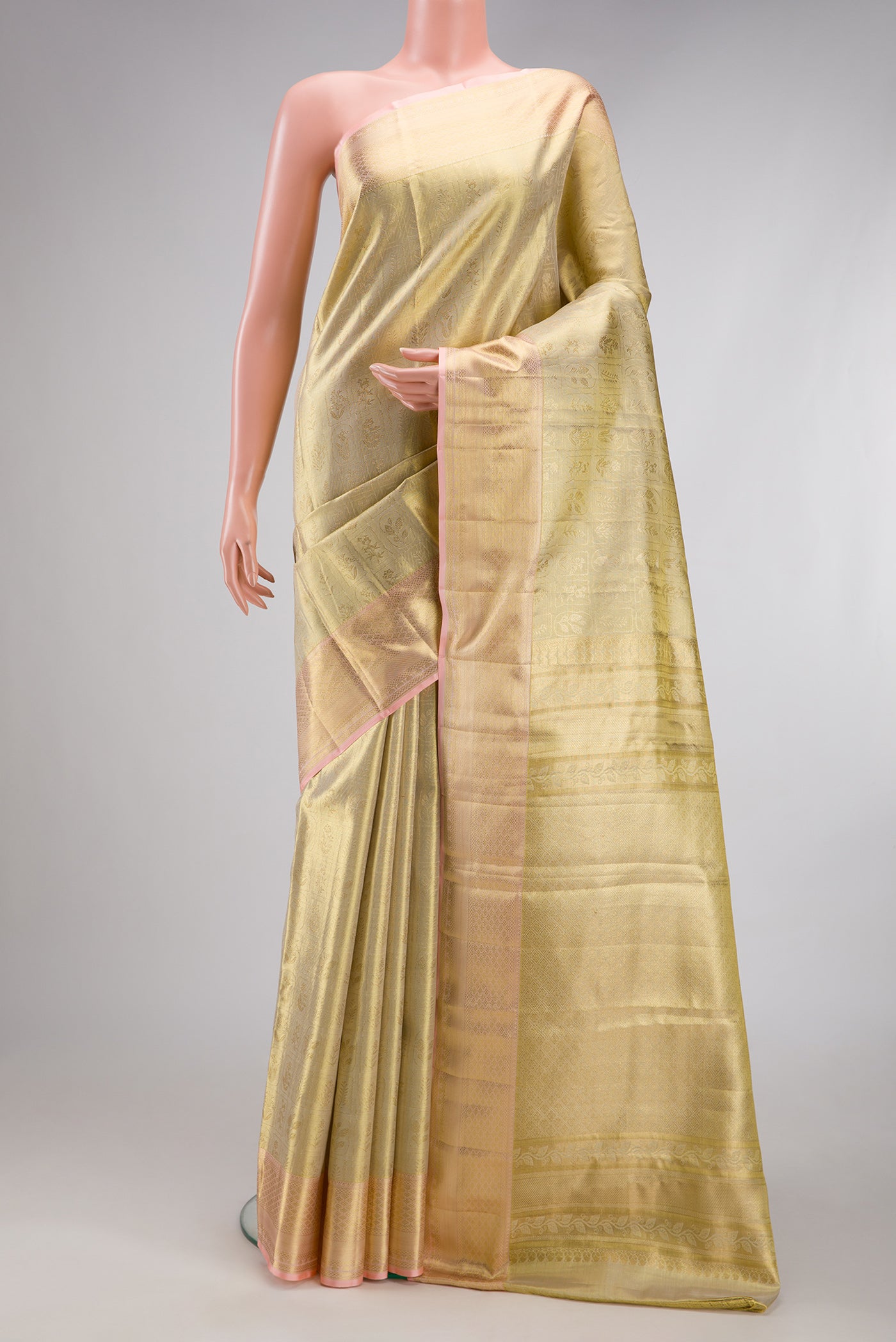 Gold Dual Tone Kanchipuram Tissue Silk Saree with Zari Brocade on the body and Zari Border.  displayed on a mannequin