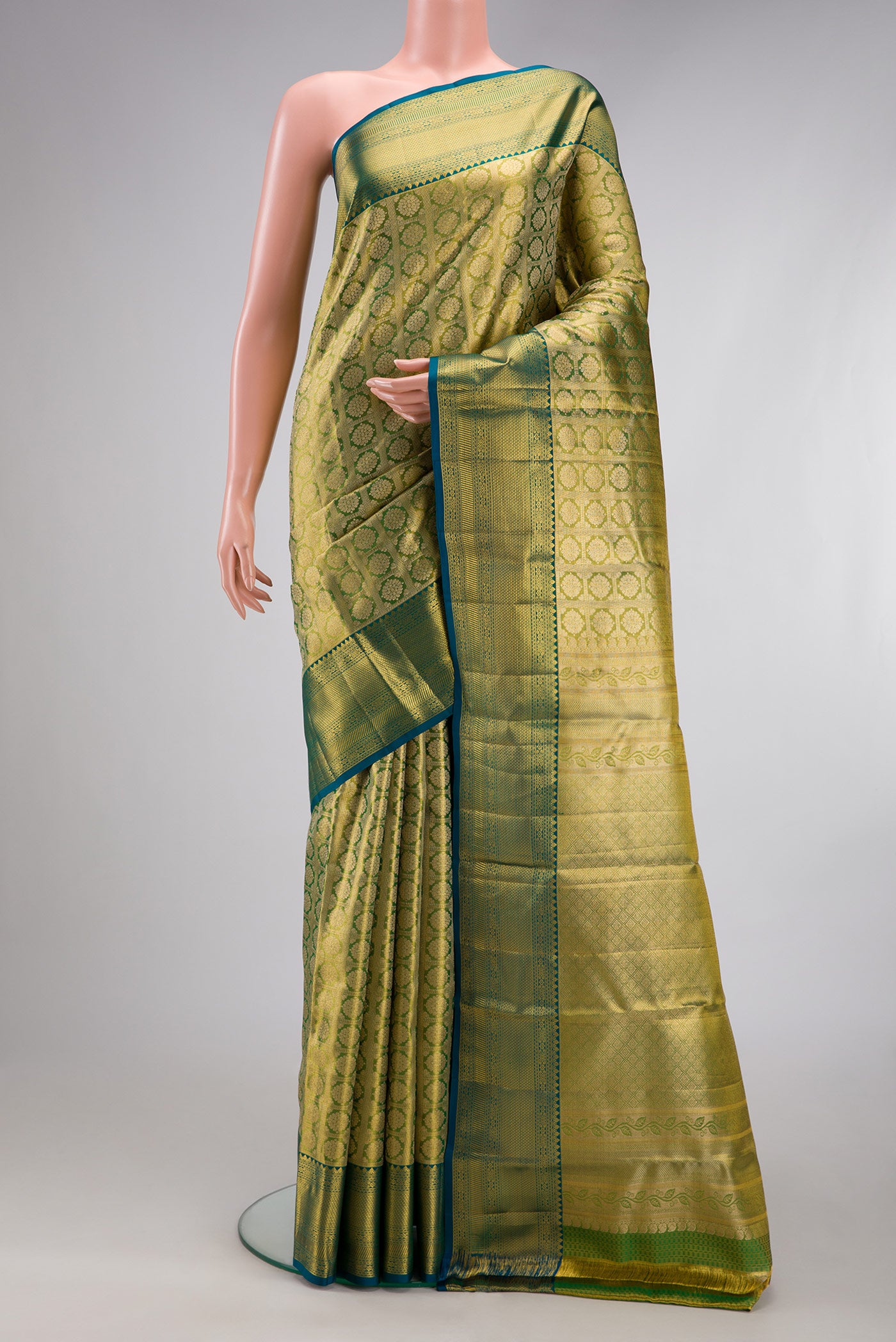 Green Dual Tone Kanchipuram Tissue Silk Saree with Zari Brocade on the body and Zari Border.  displayed on a mannequin