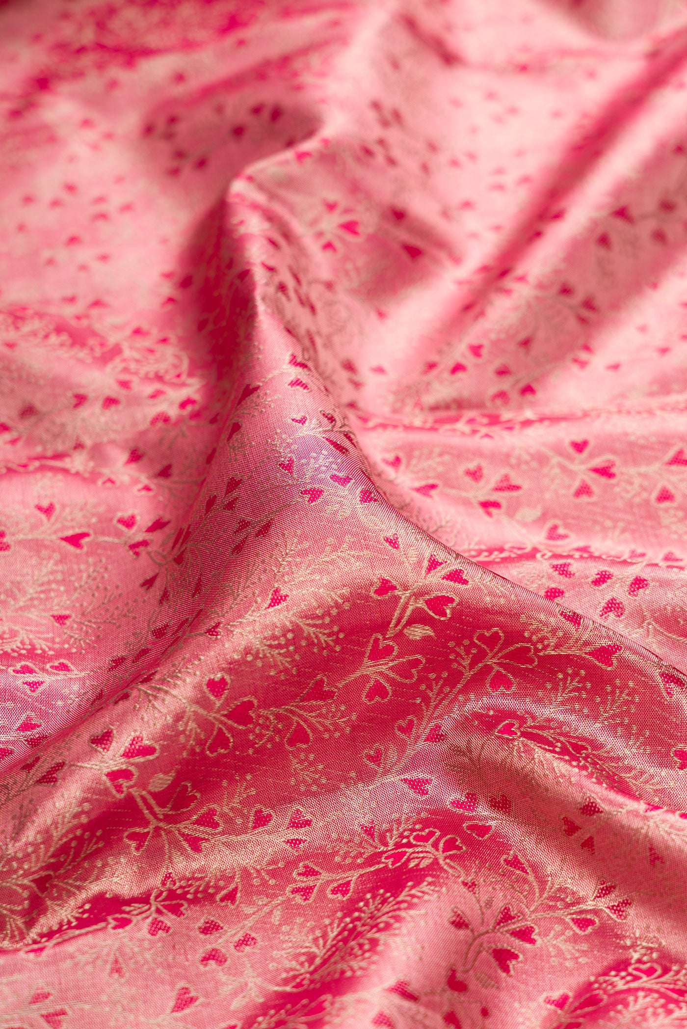 Close up of Pink Dual Tone Kanchipuram Tissue Silk Saree with Zari Brocade on the body and Fancy Border.  displaying folds