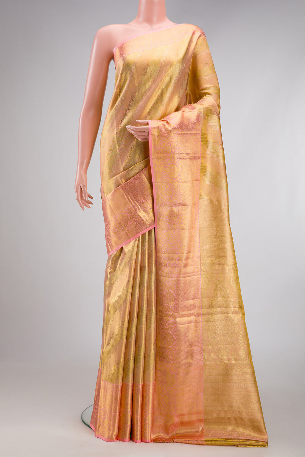 Golden Peach Dual Tone Kanchipuram Tissue Silk Saree with Zari Brocade on the body and Zari Border.  displayed on a mannequin