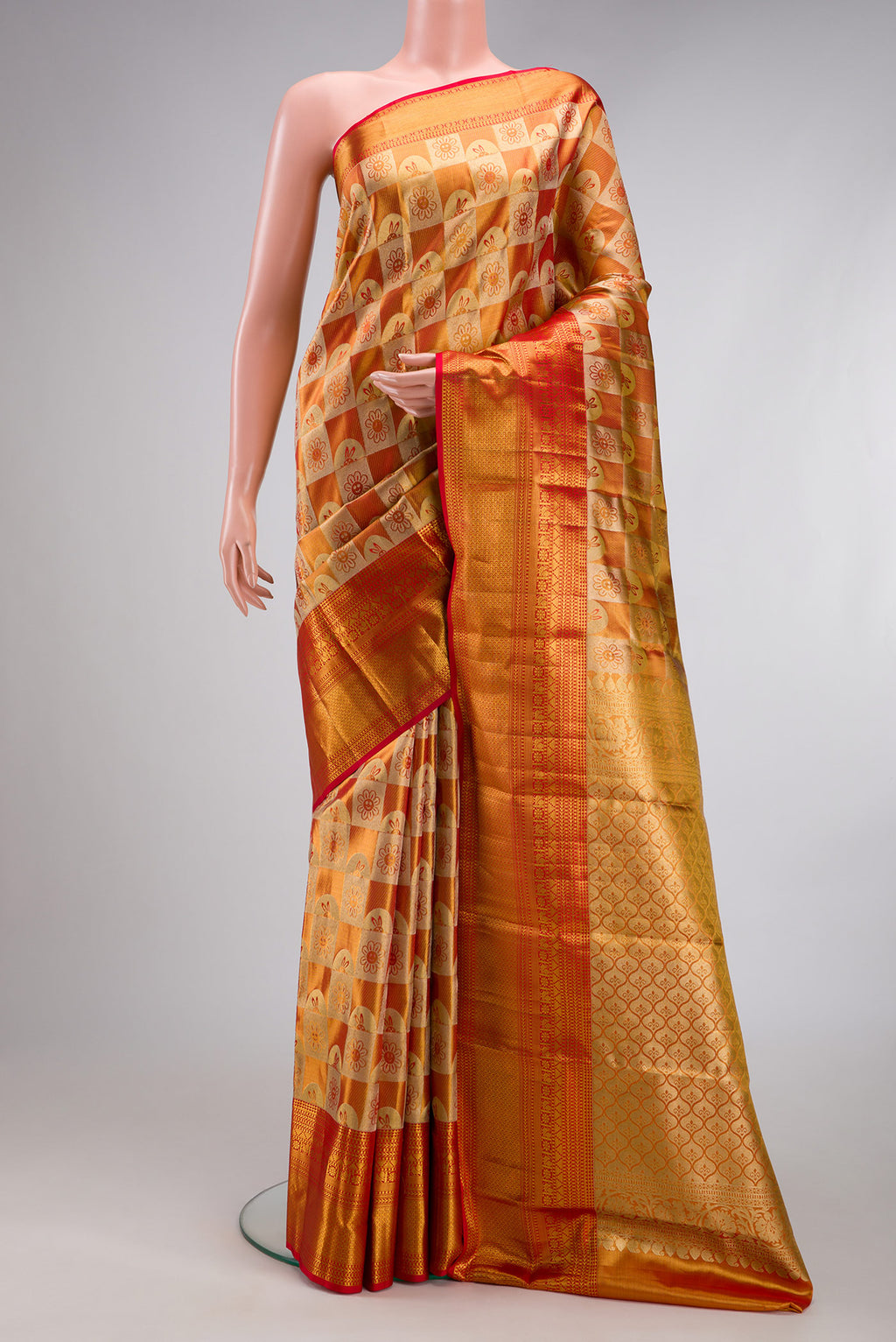 Gold Dual Tone Kanchipuram Tissue Silk Saree with Zari Brocade on the body and Zari Border.  displayed on a mannequin