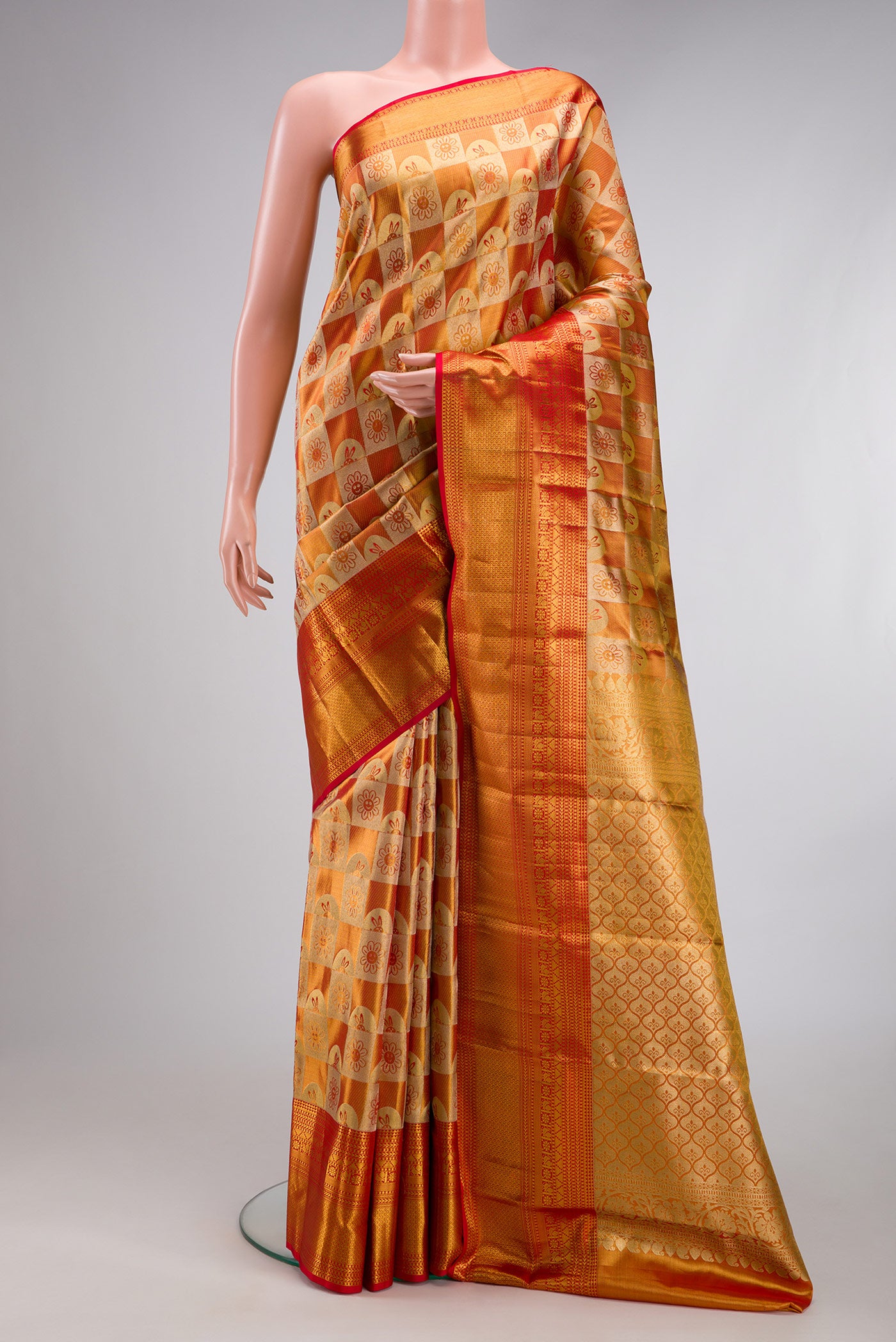 Gold Dual Tone Kanchipuram Tissue Silk Saree with Zari Brocade on the body and Zari Border.  displayed on a mannequin