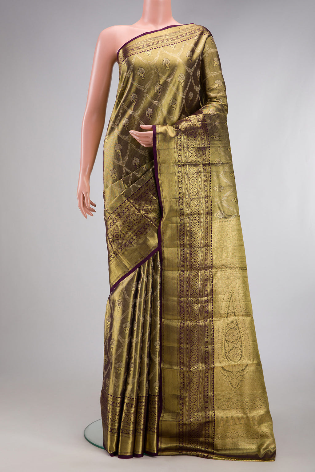 Mehandi Green Dual Tone Kanchipuram Tissue Silk Saree with Zari Brocade on the body and Zari Border.  displayed on a mannequin