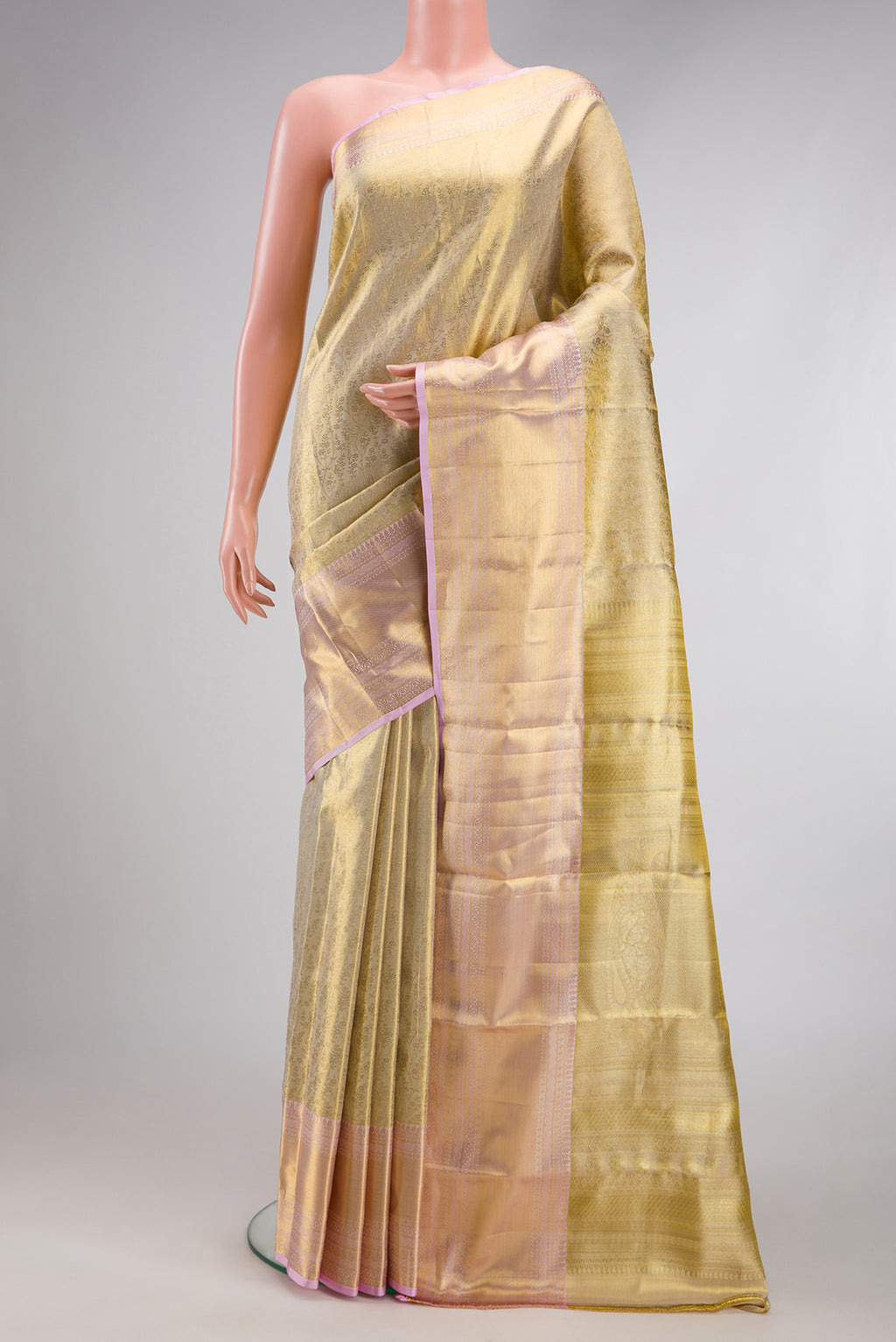 Gold Dual Tone Kanchipuram Tissue Silk Saree with Zari Brocade on the body and Zari Border.  displayed on a mannequin