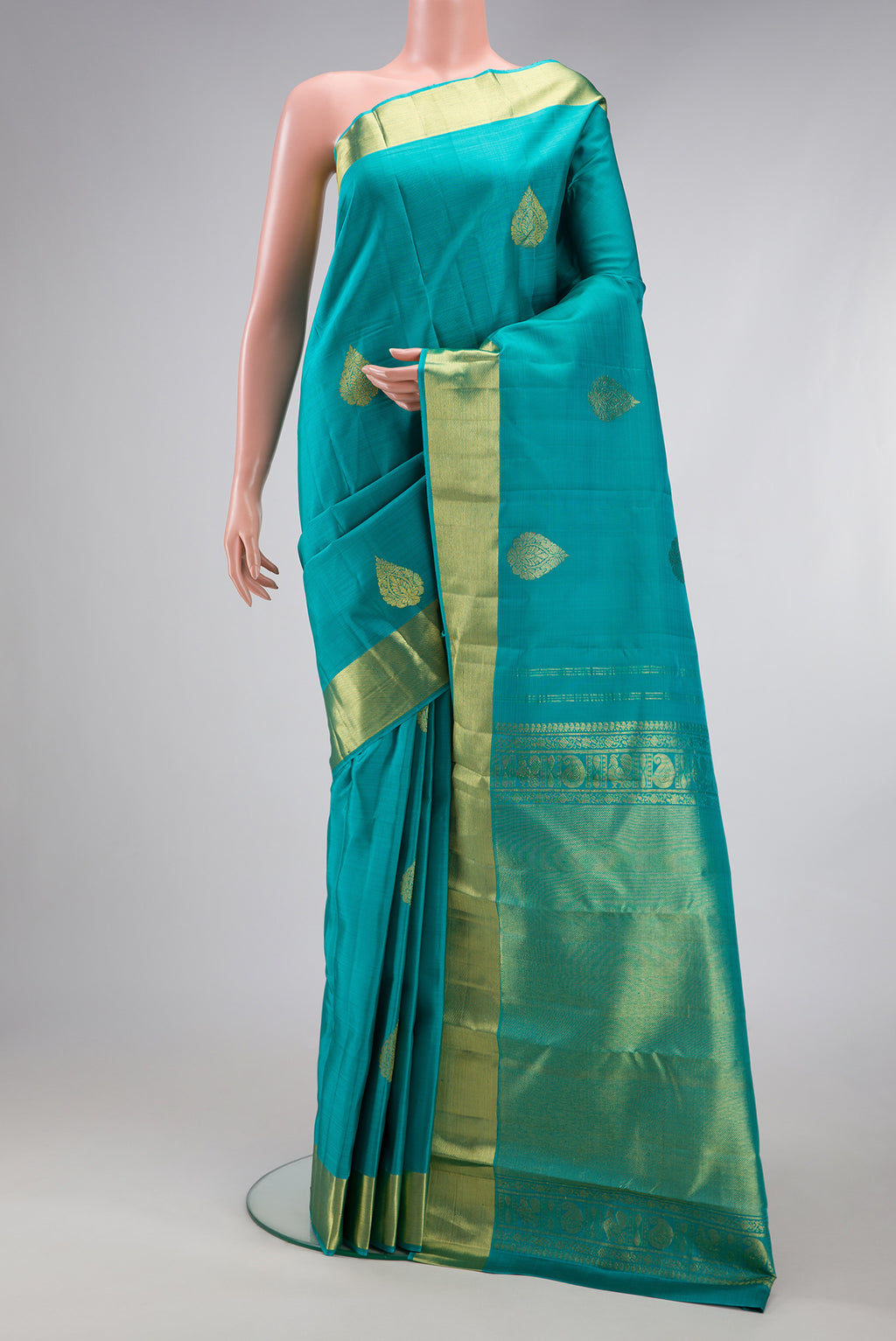 Sky Blue Kanjivaram Silk Saree with Zari Butta on the body and Zari Border.  displayed on a mannequin