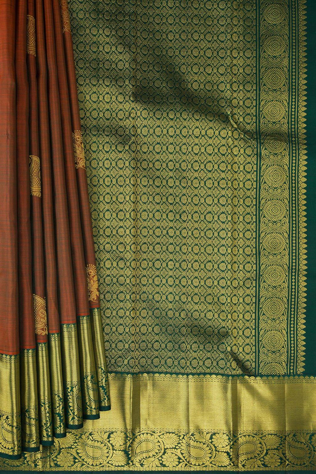 Pleats and pallu of Rust Kanjivaram Silk Saree with Zari Butta on the body and Zari Border. 