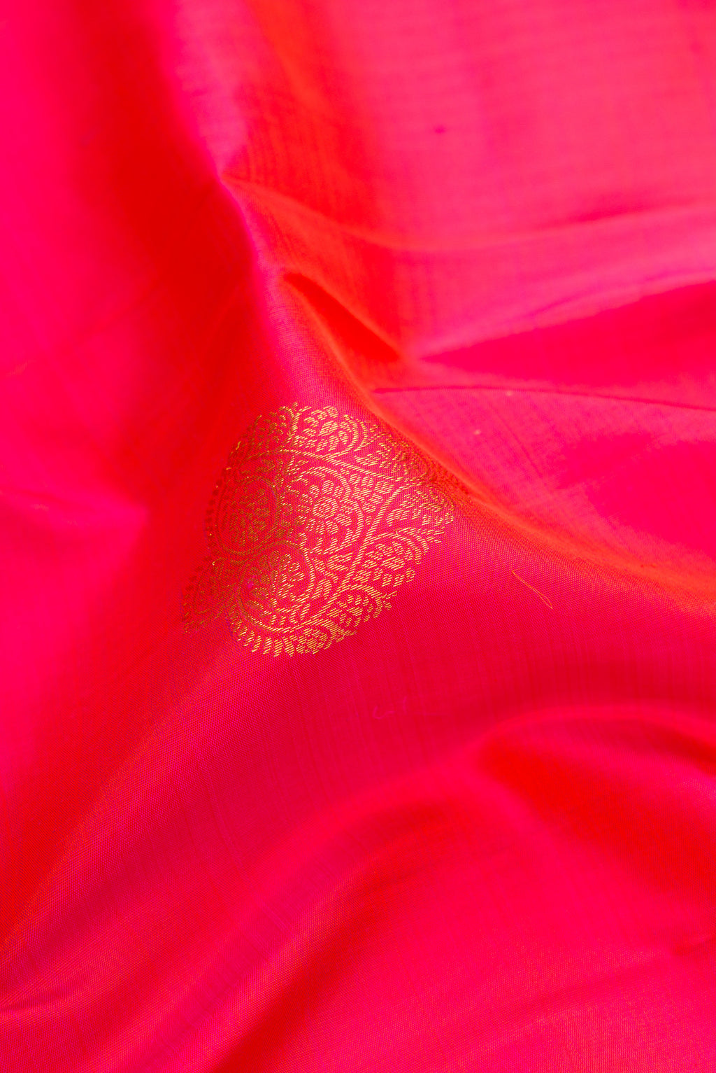 Close up of Pink Dual Tone Kanjivaram Silk Saree with Zari Butta on the body and Zari Border.  displaying folds