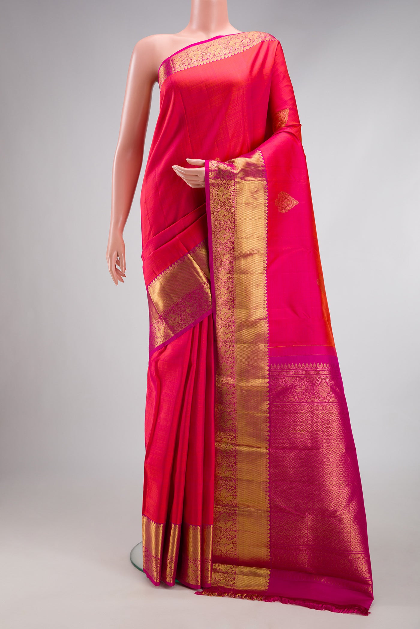 Pink Dual Tone Kanjivaram Silk Saree with Zari Butta on the body and Zari Border.  displayed on a mannequin