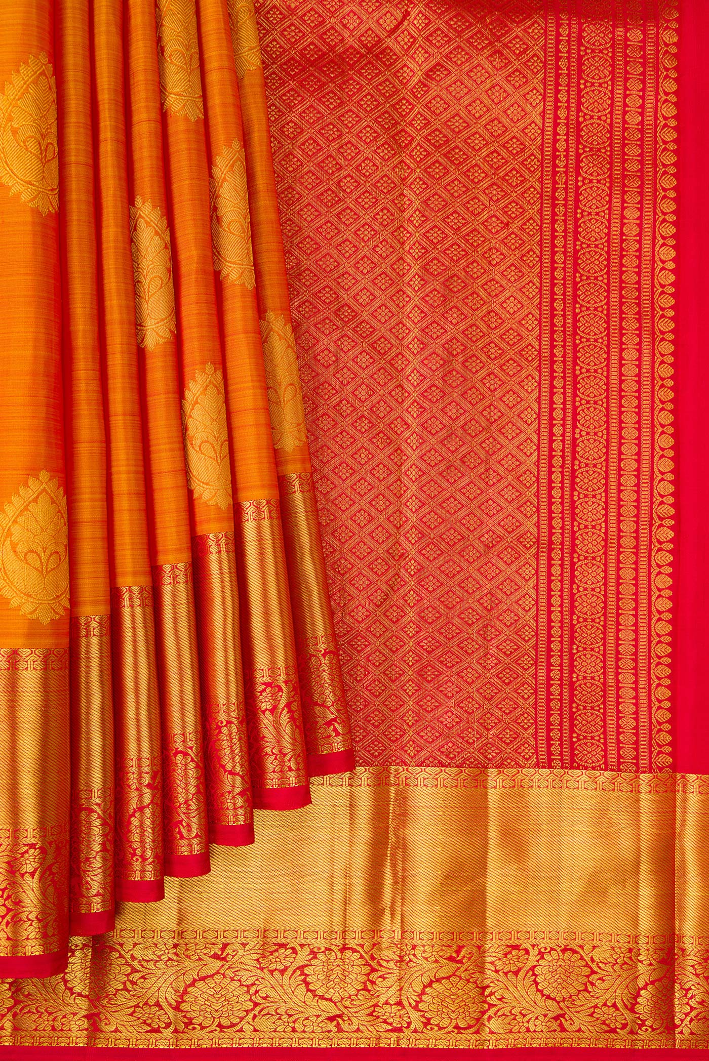 Pleats and pallu of Mustard Kanjivaram Silk Saree with Zari Butta on the body and Zari Border. 