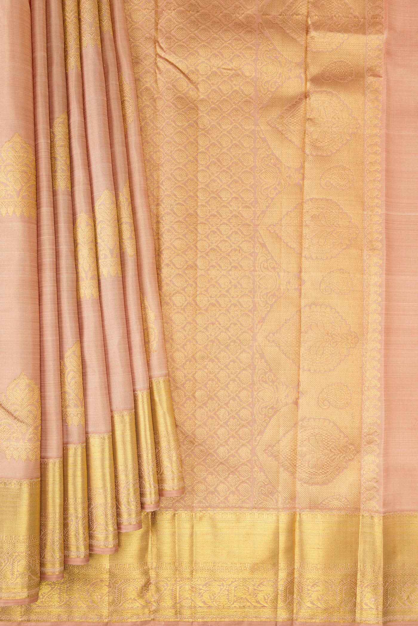 Pleats and pallu of Golden Peach Kanjivaram Silk Saree with Zari Butta on the body and Zari Border. 