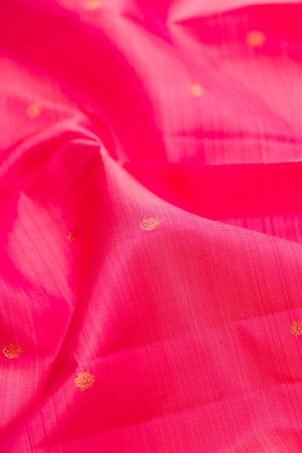 Close up of Pink Kanjivaram Silk Saree with Zari Butta on the body and Zari Border.  displaying folds