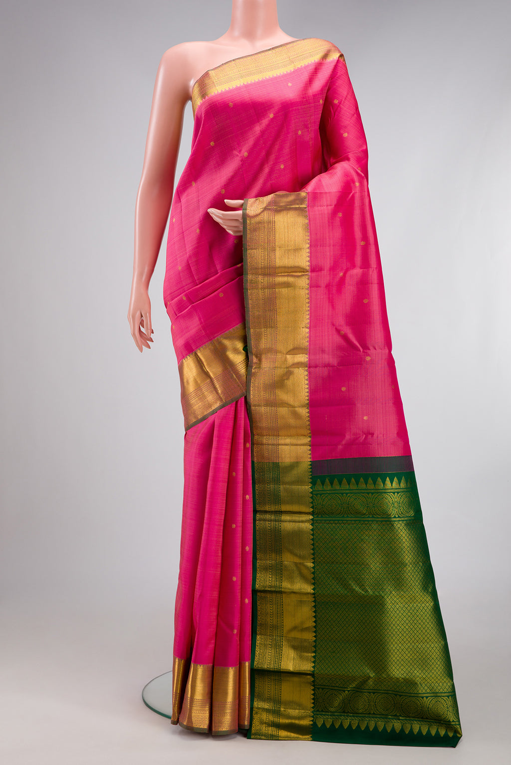 Pink Kanjivaram Silk Saree with Zari Butta on the body and Zari Border.  displayed on a mannequin