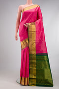 Pink Kanjivaram Silk Saree with Zari Butta on the body and Zari Border.  displayed on a mannequin