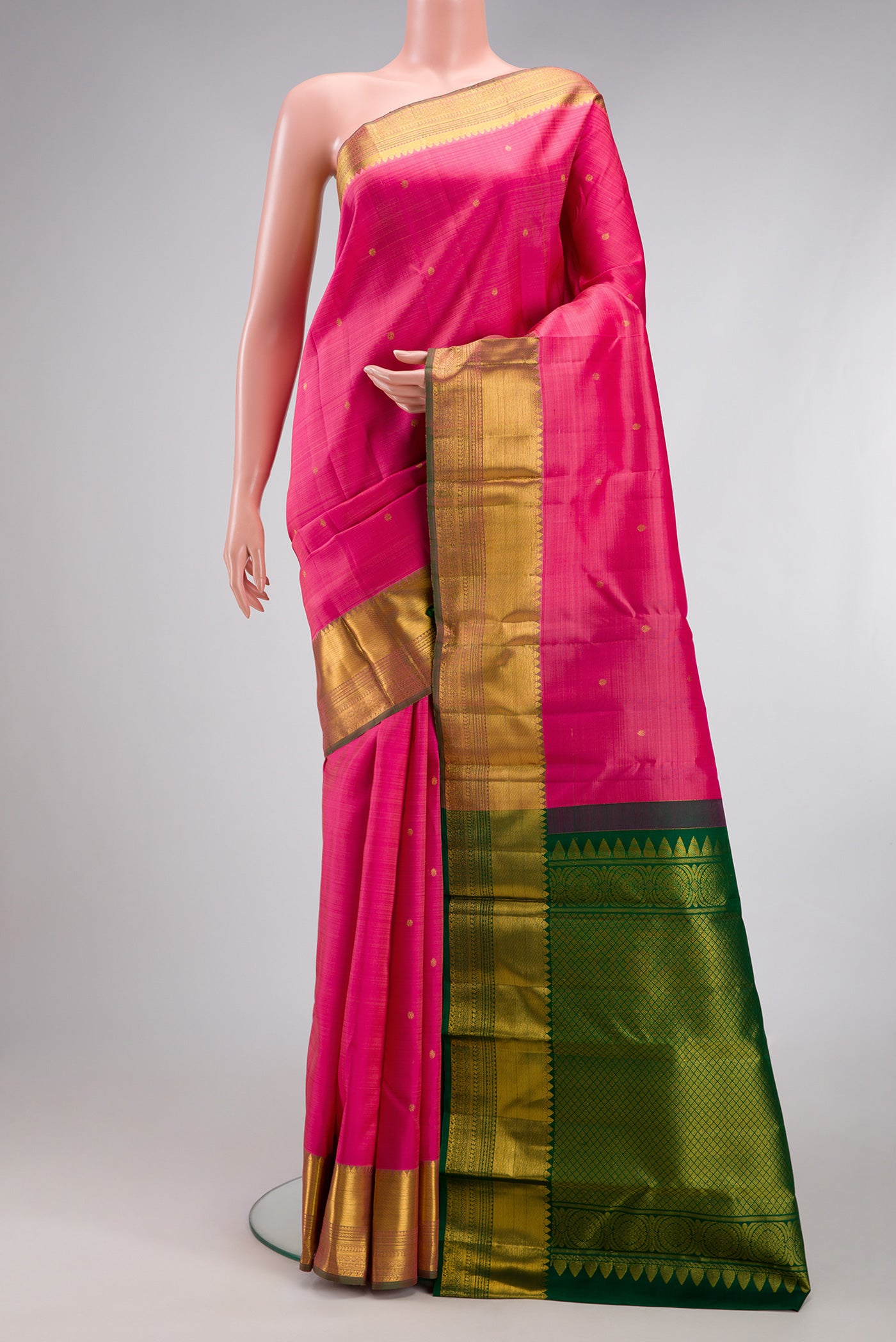 Pink Kanjivaram Silk Saree with Zari Butta on the body and Zari Border.  displayed on a mannequin