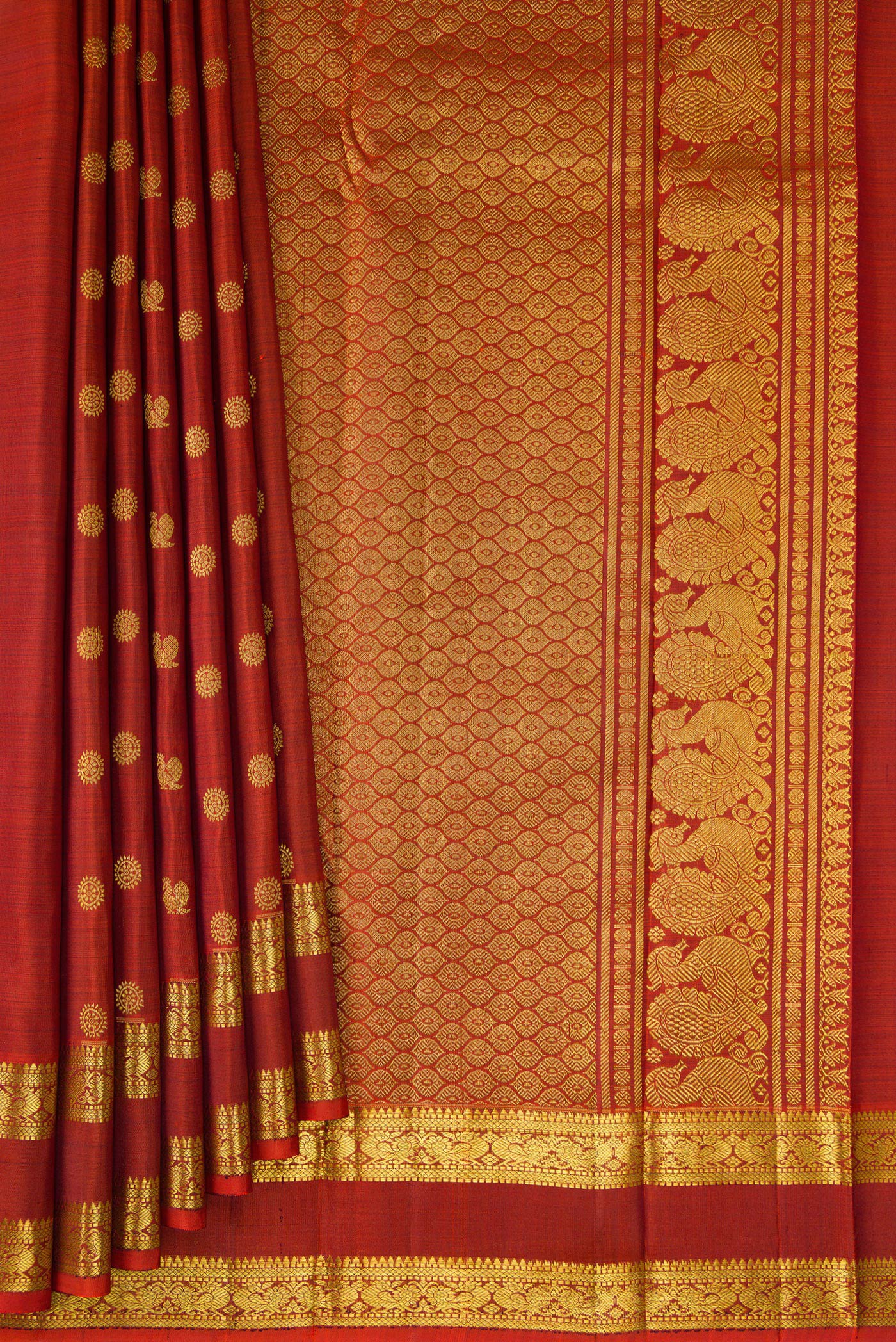 Pleats and pallu of Rust Kanjivaram Silk Saree with Zari Butta on the body and Zari Border. 