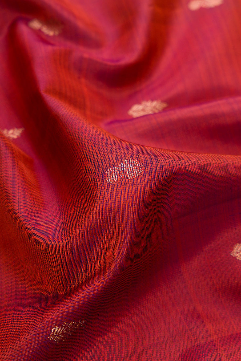 Close up of Orange with Magenta Color Kanjivaram Silk Saree with Zari Butta on the body and Zari Border.  displaying folds
