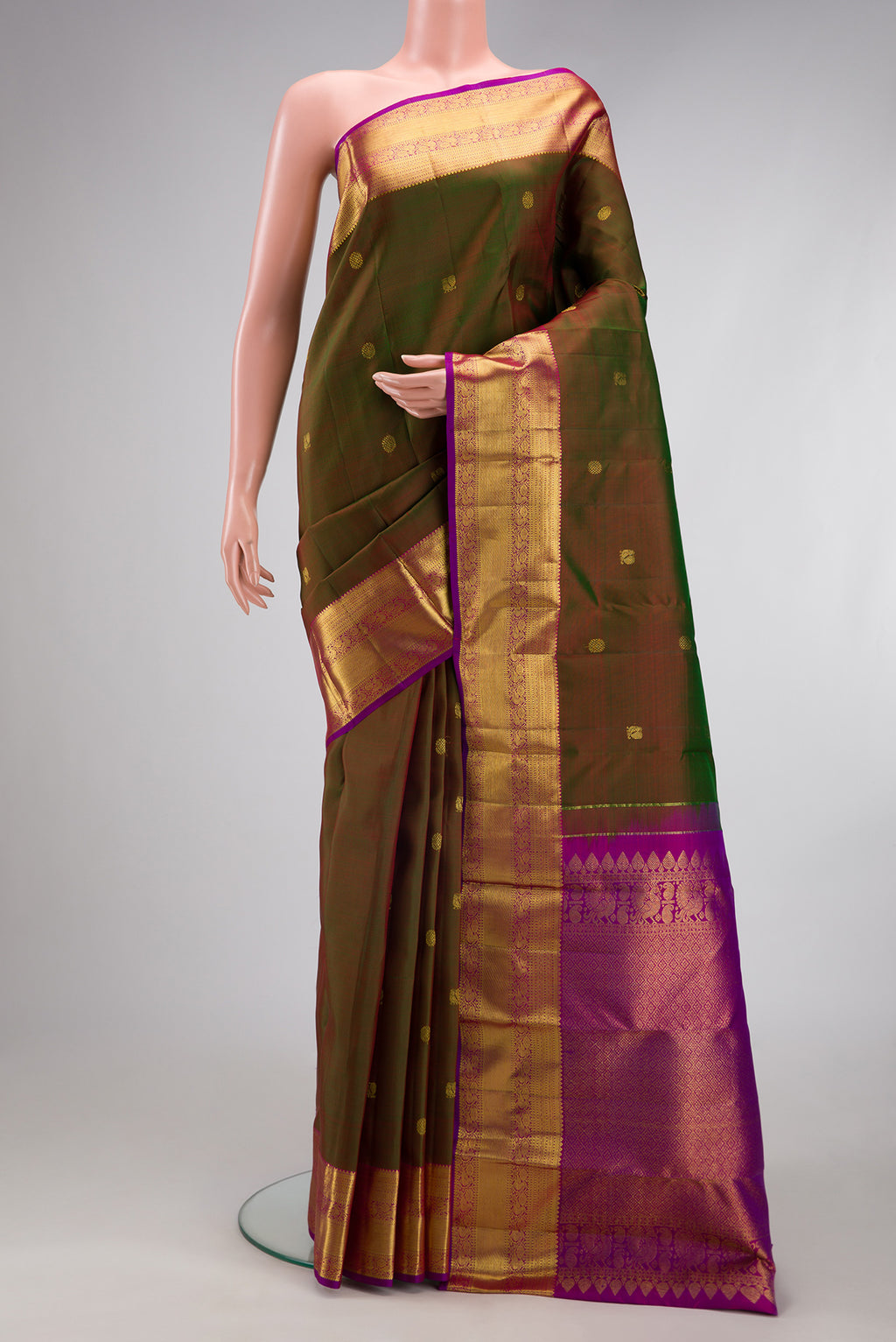 Mehandi Green Dual Tone Kanjivaram Silk Saree with Zari Butta on the body and Zari Border.  displayed on a mannequin