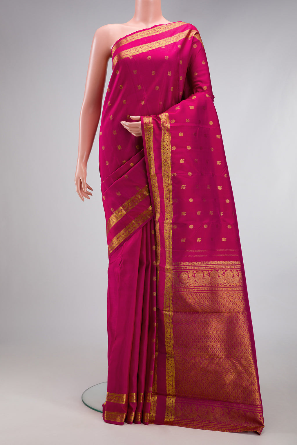 Dark Pink Kanjivaram Silk Saree with Zari Butta on the body and Zari Border.  displayed on a mannequin