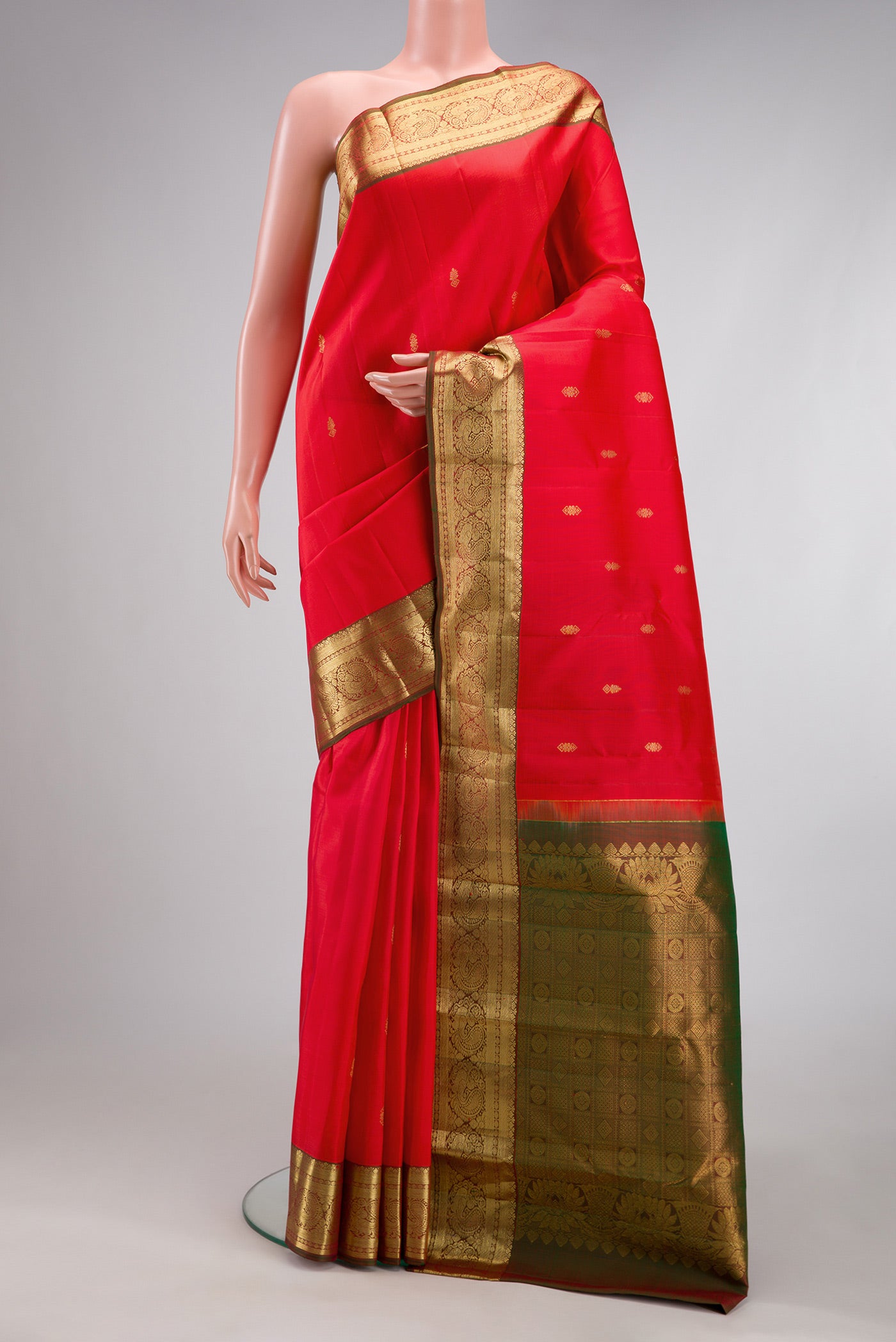 Red Kanjivaram Silk Saree with Zari Butta on the body and Zari Border.  displayed on a mannequin