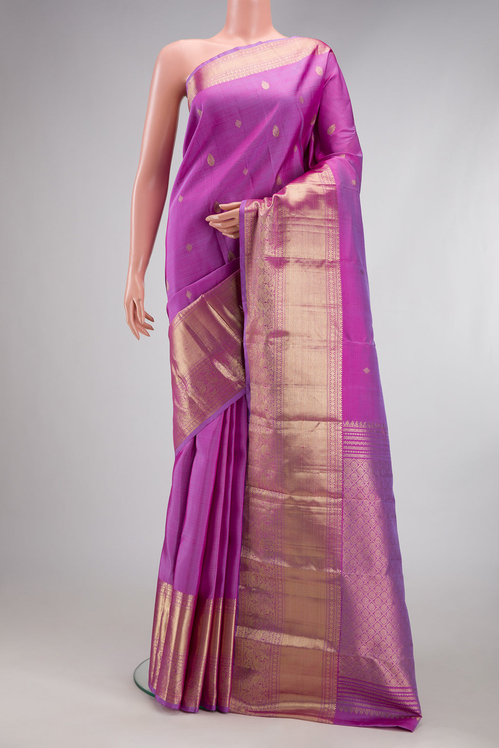 Lavender Kanchipuram Silk Saree with Zari Butta on the body and Zari Border.  displayed on a mannequin