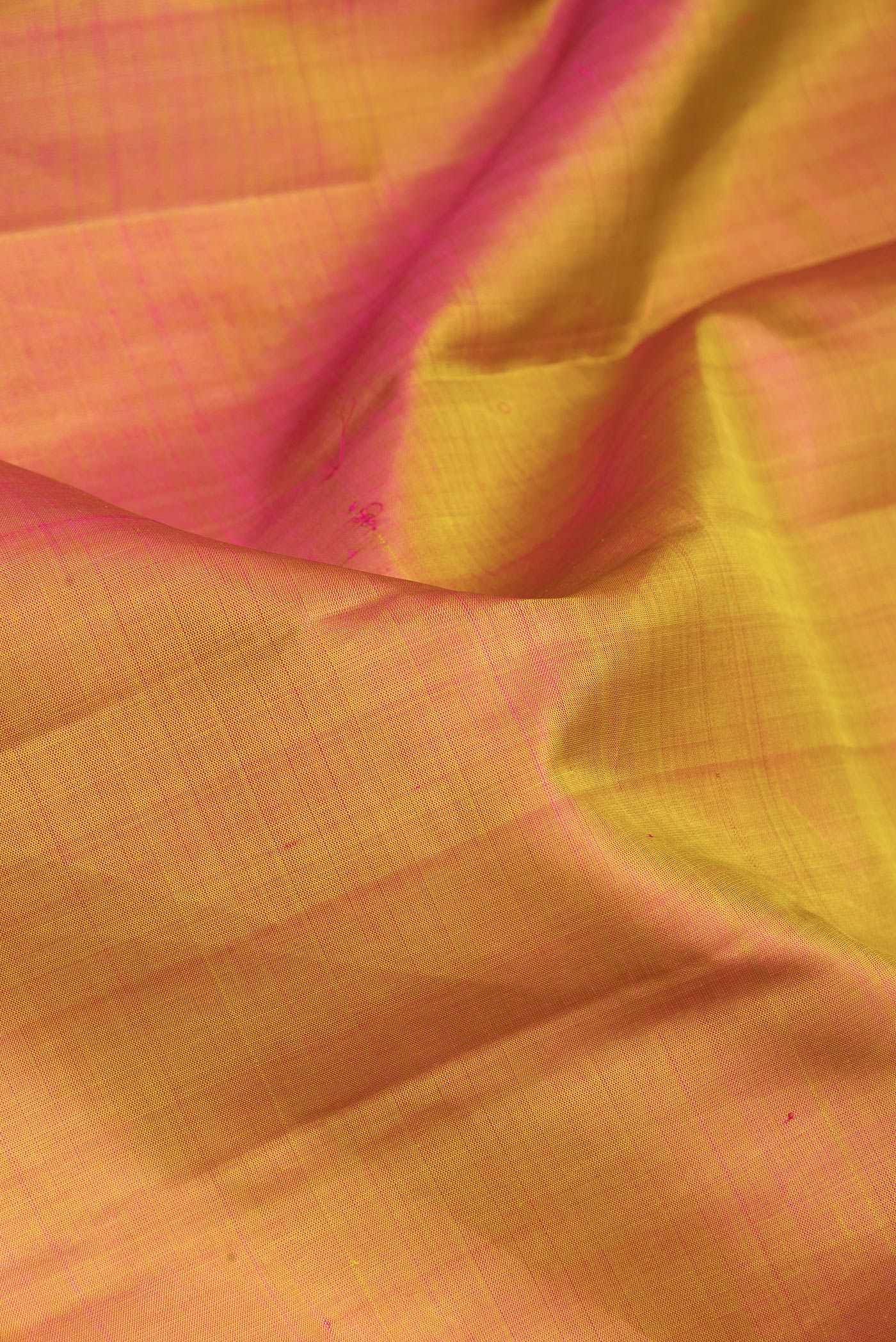 Close up of Mustard Dual Tone Kanjivaram Silk Saree with Plain Body and Zari Border.  displaying folds
