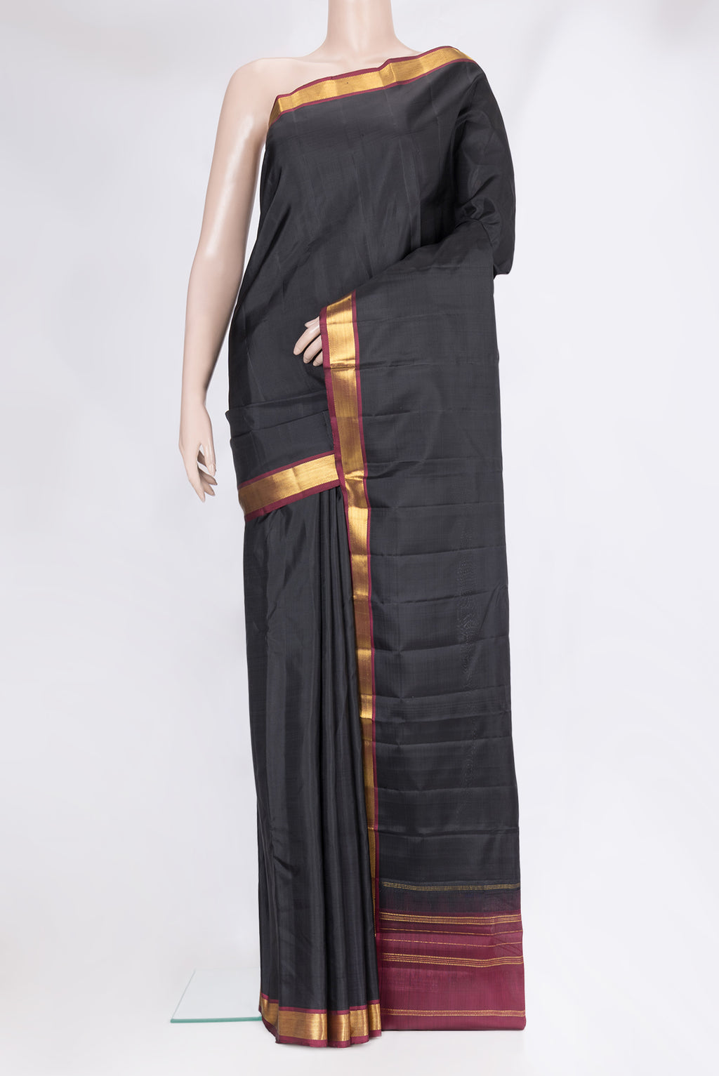 Black Kanjivaram Silk Saree with Plain Body and Zari Border.  displayed on a mannequin