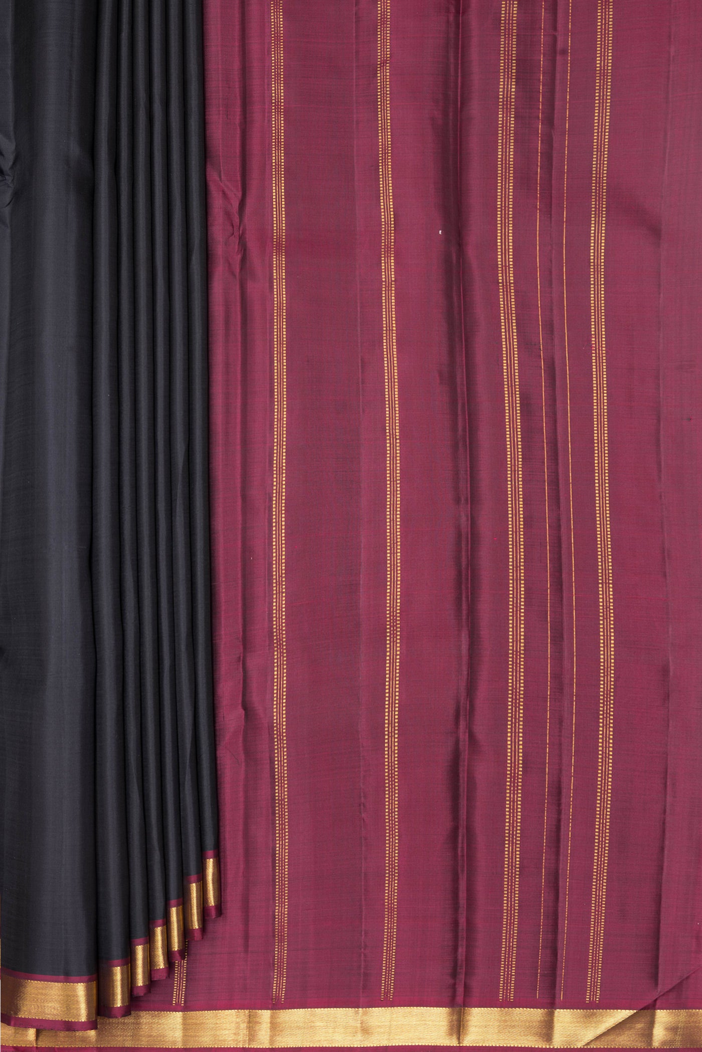 Pleats and pallu of Black Kanjivaram Silk Saree with Plain Body and Zari Border. 