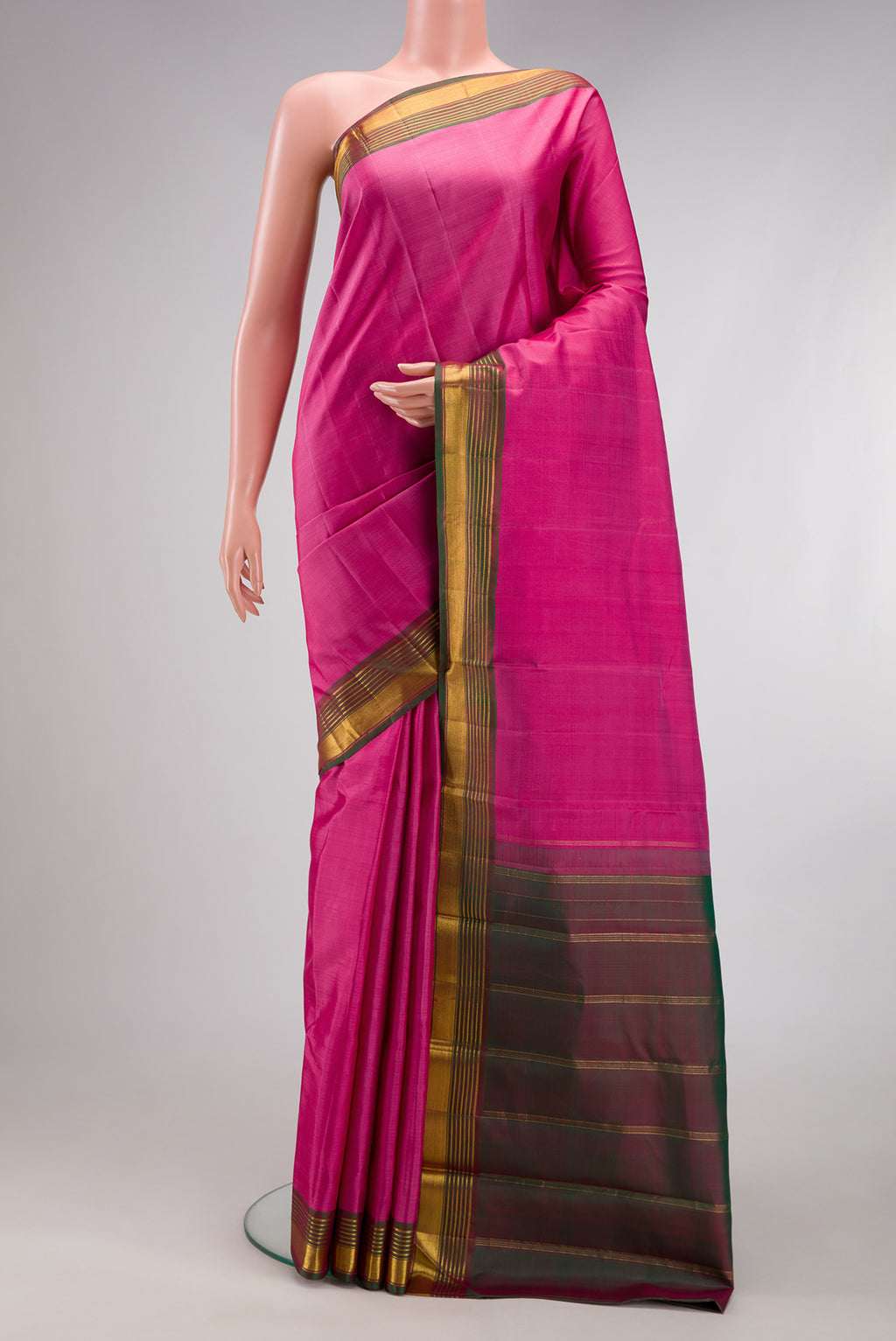 Pink Kanjivaram Silk Saree with Plain Body and Zari Border.  displayed on a mannequin