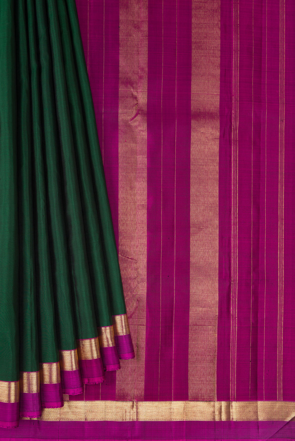 Pleats and pallu of Bottle Green Kanjivaram Silk Saree with Plain Body and Zari Border. 