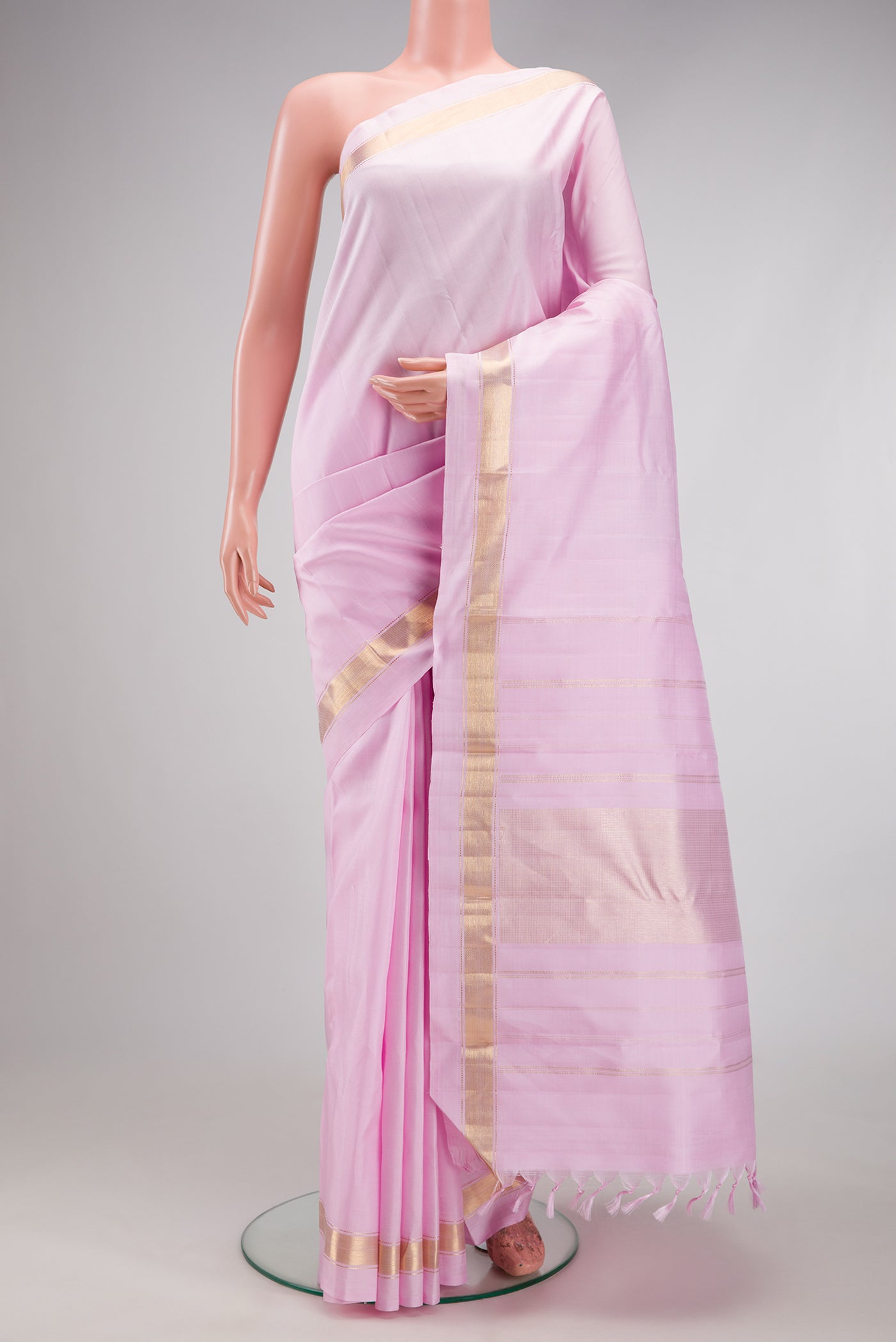 Lavender Kanjivaram Silk Saree with Plain Body and Zari Border.  displayed on a mannequin
