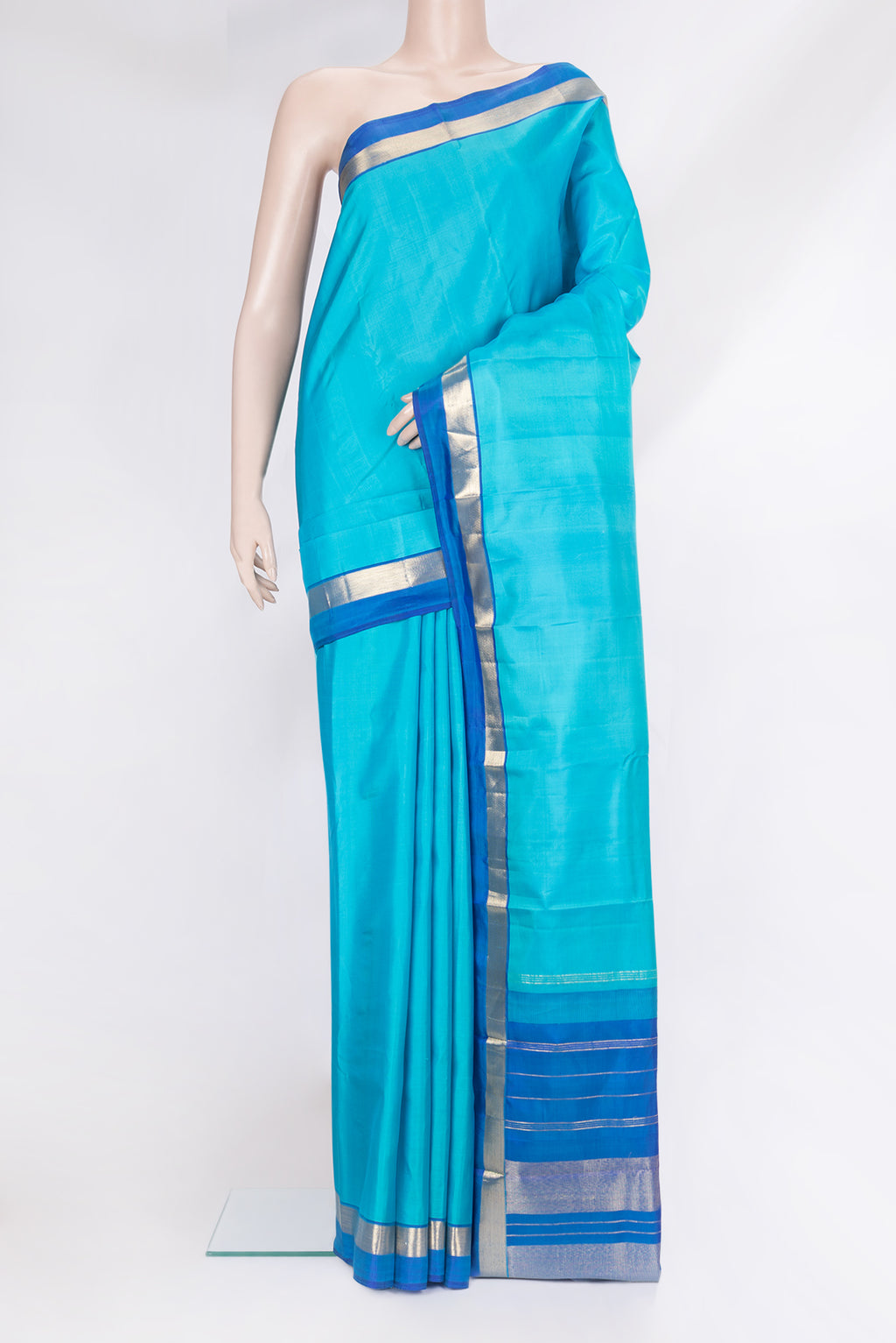 Light Blue Kanjivaram Silk Saree with Plain Body and Zari Border.  displayed on a mannequin