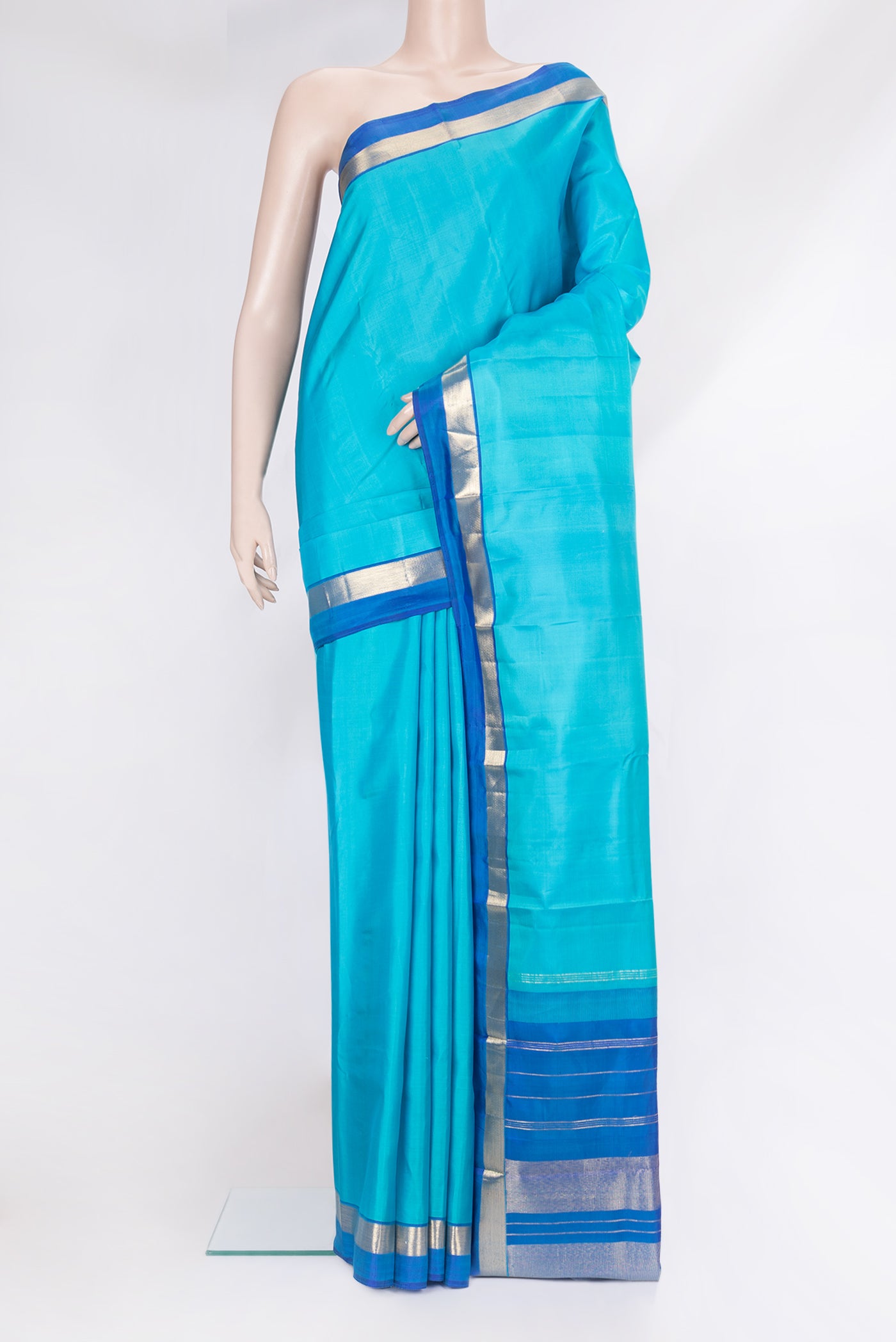 Light Blue Kanjivaram Silk Saree with Plain Body and Zari Border.  displayed on a mannequin
