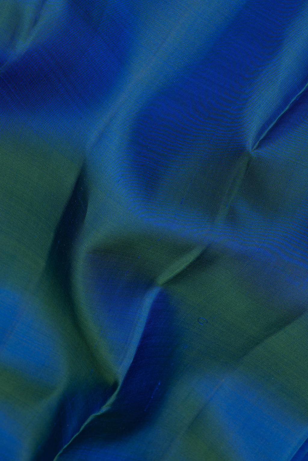 Close up of Peacock Blue Kanjivaram Silk Saree with Plain Body and Zari Border.  displaying folds