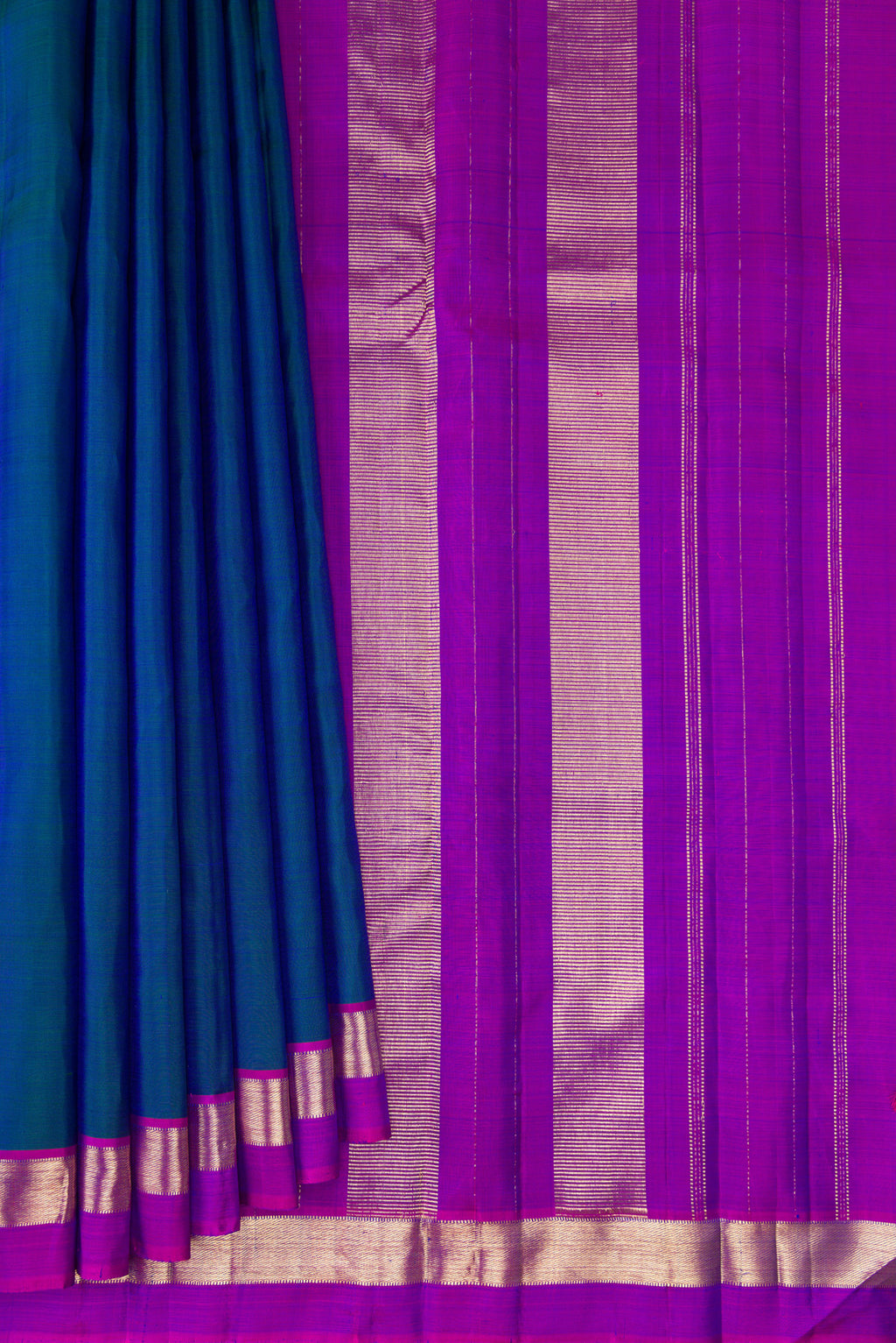Pleats and pallu of Peacock Blue Kanjivaram Silk Saree with Plain Body and Zari Border. 