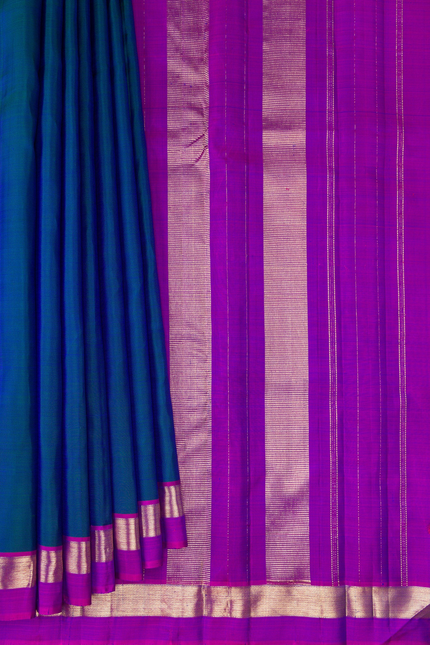 Pleats and pallu of Peacock Blue Kanjivaram Silk Saree with Plain Body and Zari Border. 