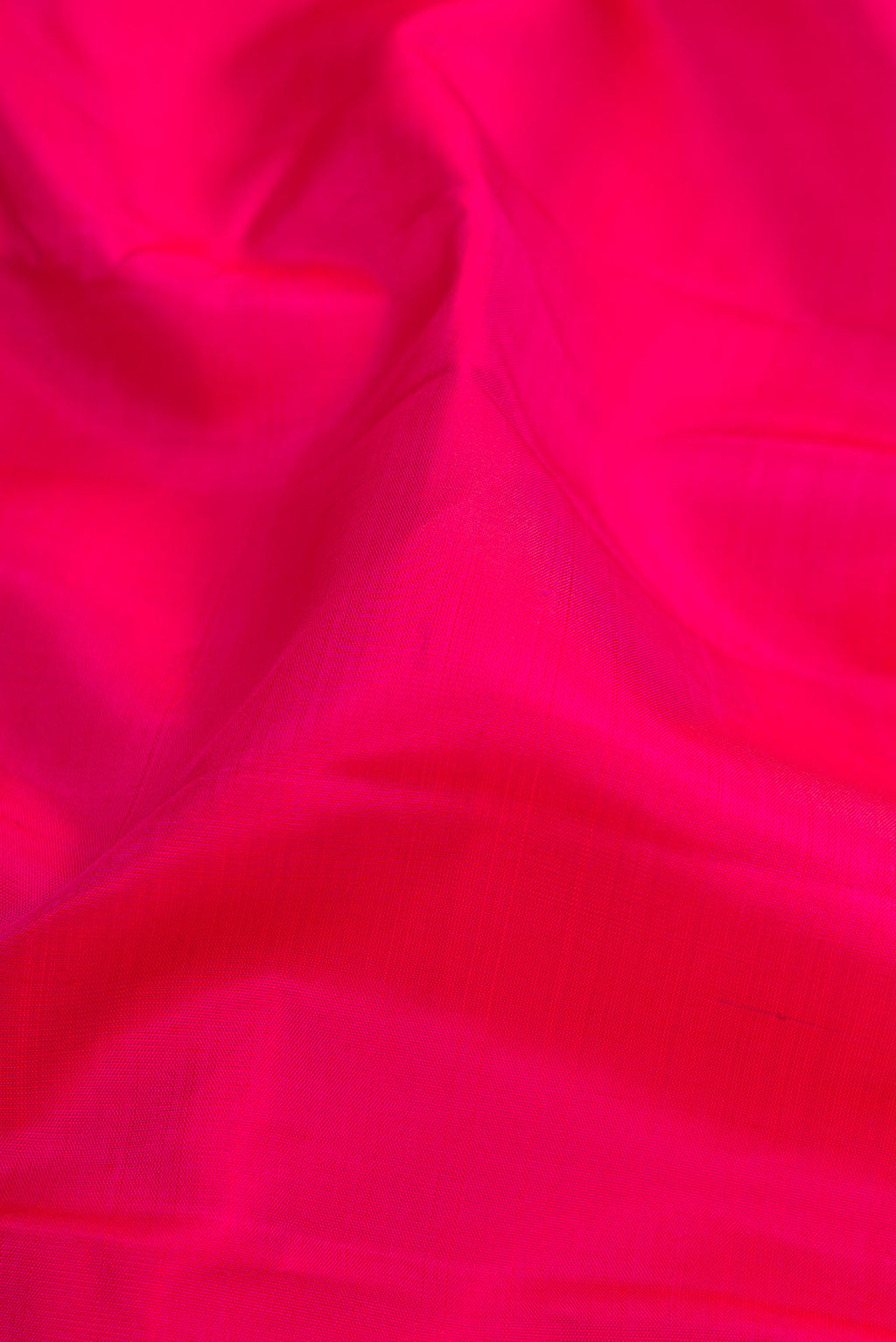 Close up of Pink Kanjivaram Silk Saree with Plain Body and Zari Border.  displaying folds