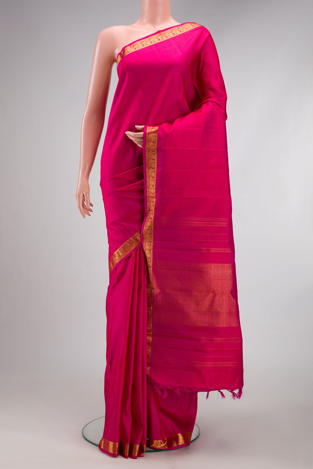 Pink Kanjivaram Silk Saree with Plain Body and Zari Border.  displayed on a mannequin