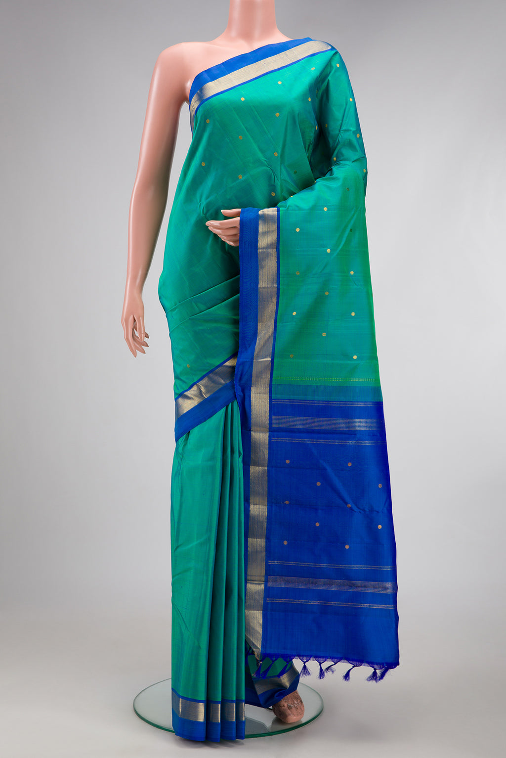 Sea Green Dual Tone Kanjivaram Silk Saree with Zari Butta on the body and Zari Border.  displayed on a mannequin