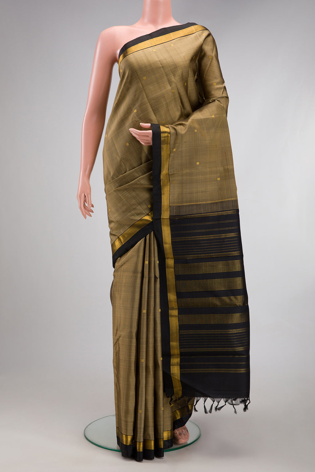 Dark Beige Kanjivaram Silk Saree with Zari Butta on the body and Zari Border.  displayed on a mannequin