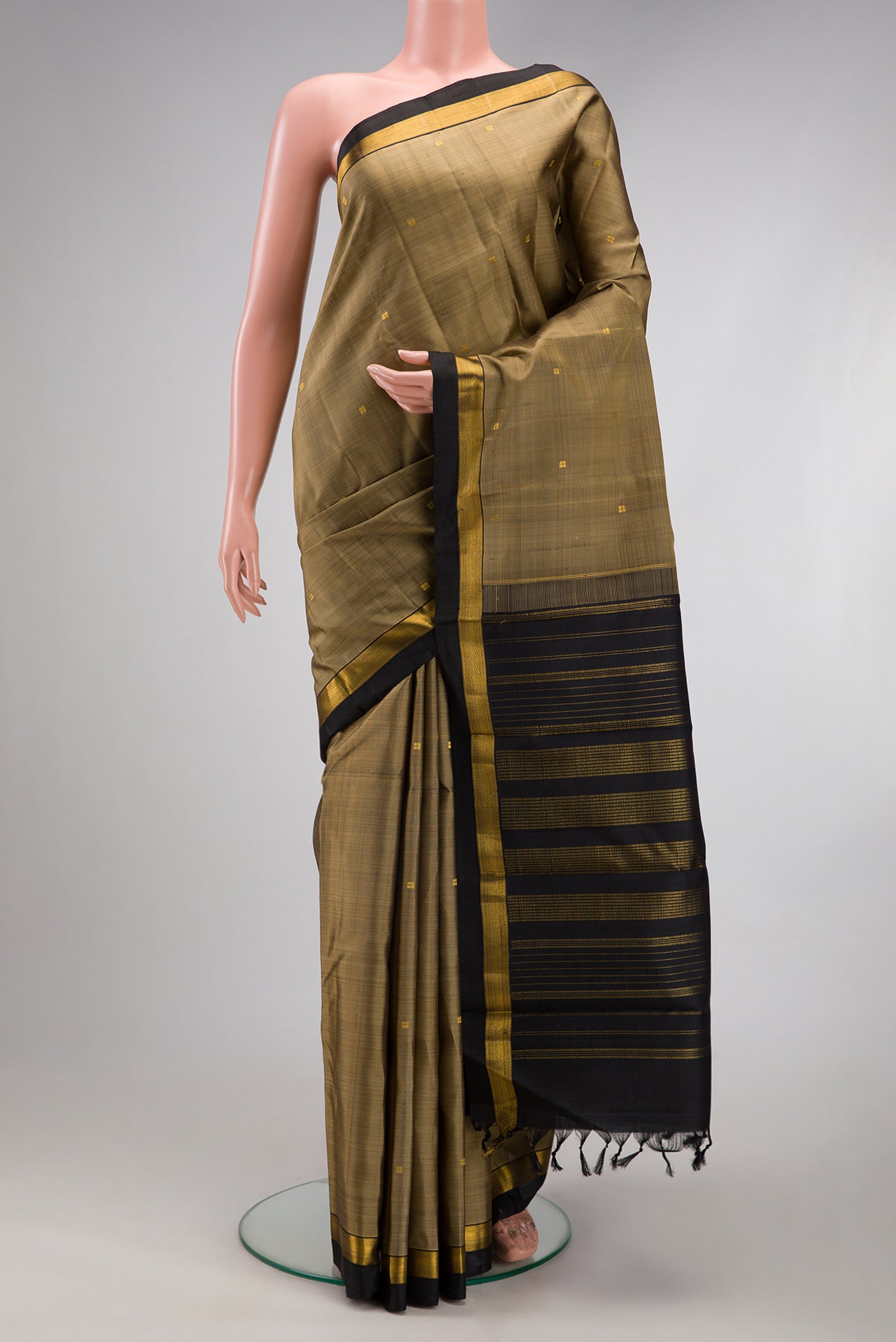 Dark Beige Kanjivaram Silk Saree with Zari Butta on the body and Zari Border.  displayed on a mannequin