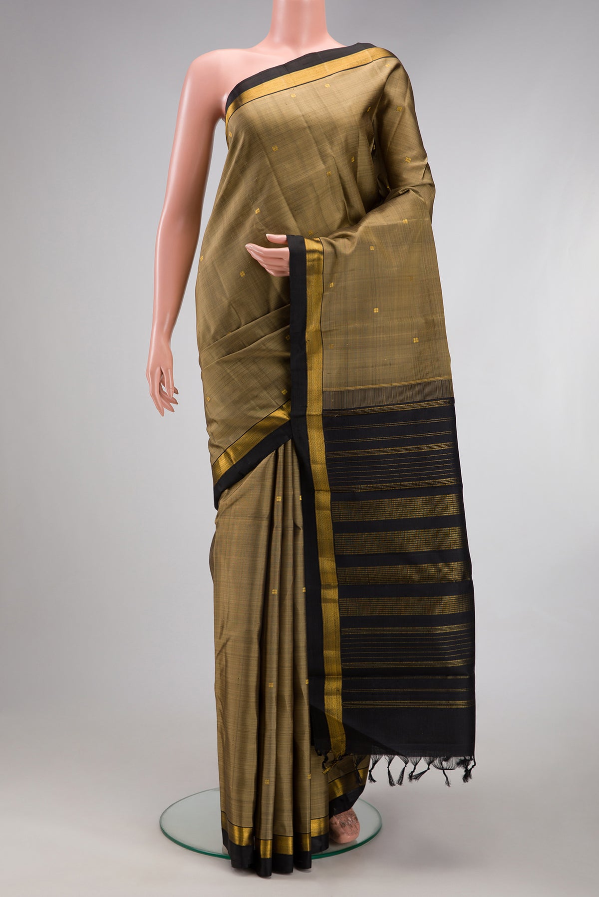 Dark Beige Kanjivaram Silk Saree with Zari Butta on the body and Zari Border.  displayed on a mannequin