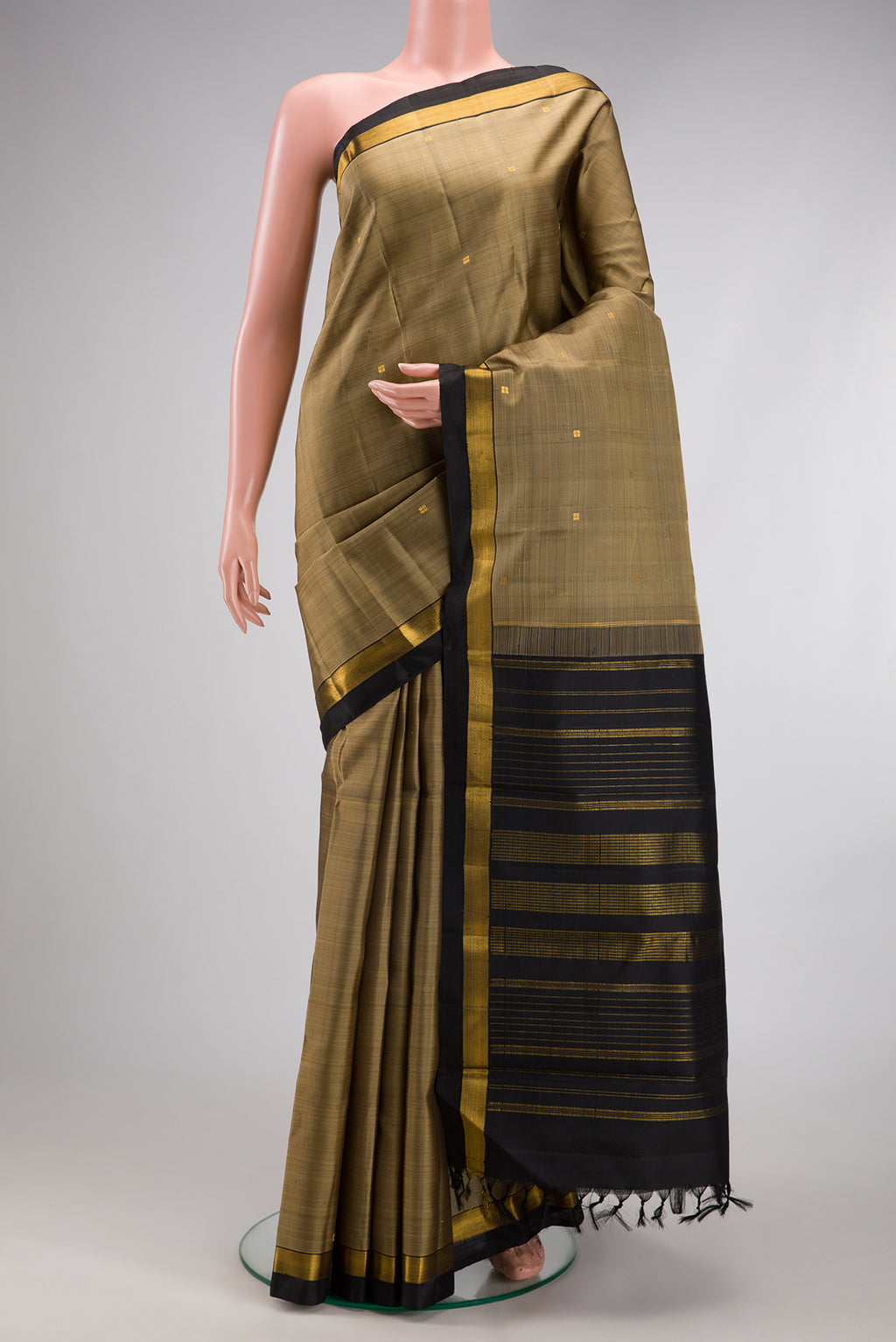 Dark Beige Kanjivaram Silk Saree with Zari Butta on the body and Zari Border.  displayed on a mannequin