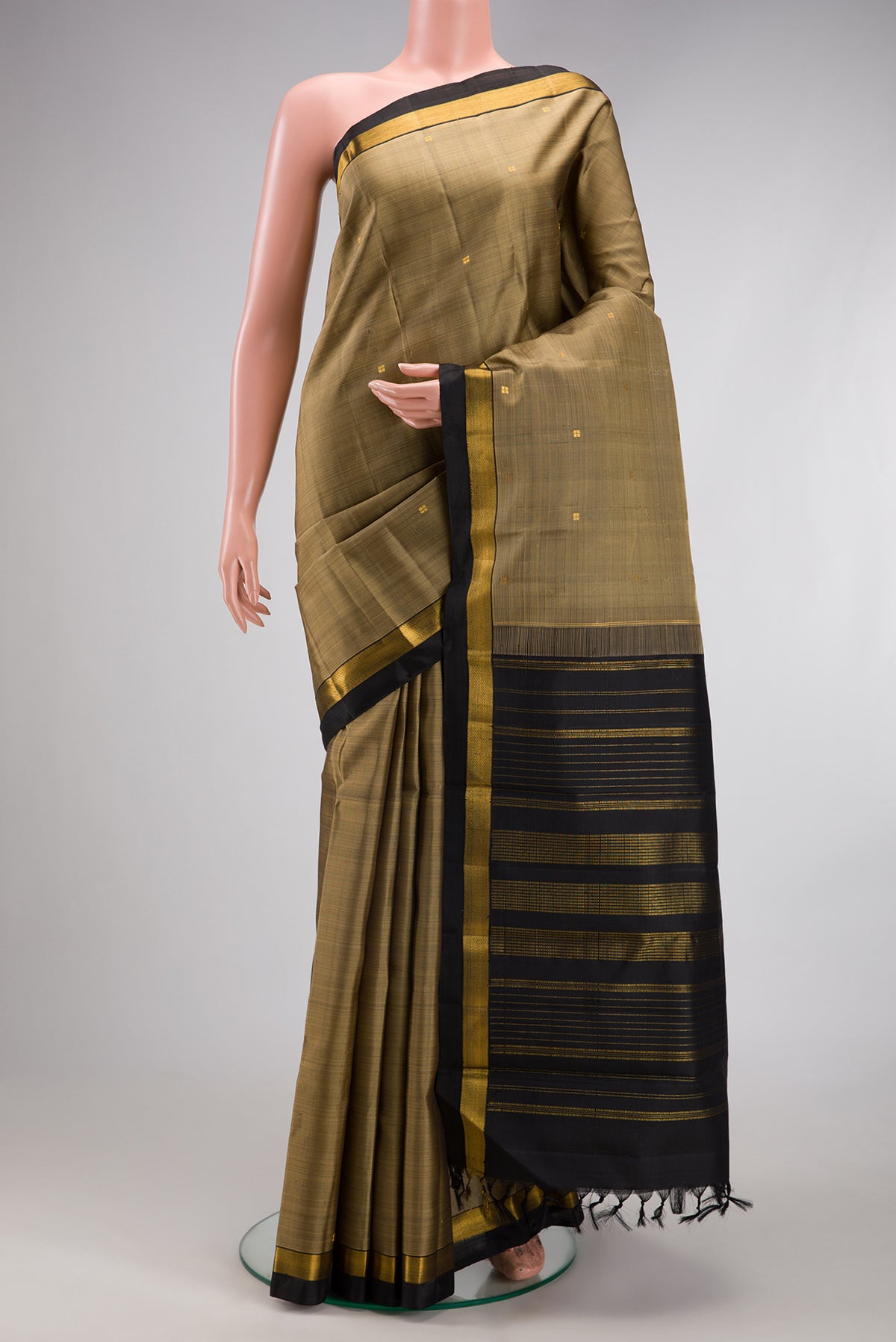 Dark Beige Kanjivaram Silk Saree with Zari Butta on the body and Zari Border.  displayed on a mannequin