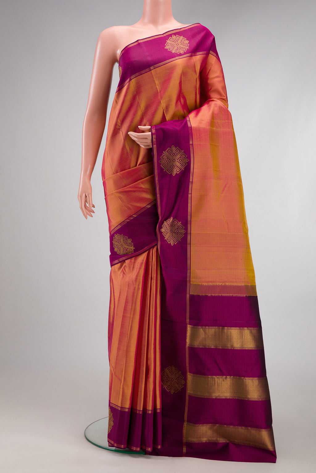 Pinkish Yellow Dual Tone Kanchipuram Silk Saree with Plain Body and Fancy Border.  displayed on a mannequin