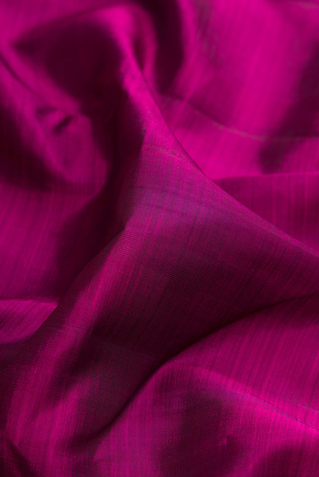 Close up of Purple Kanchipuram Silk Saree with Plain Body and Zari Border.  displaying folds
