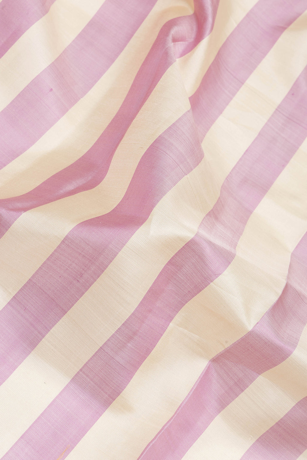 Close up of Multi Color Kanchipuram Silk Saree with Stripes on the body and Zari Border.  displaying folds