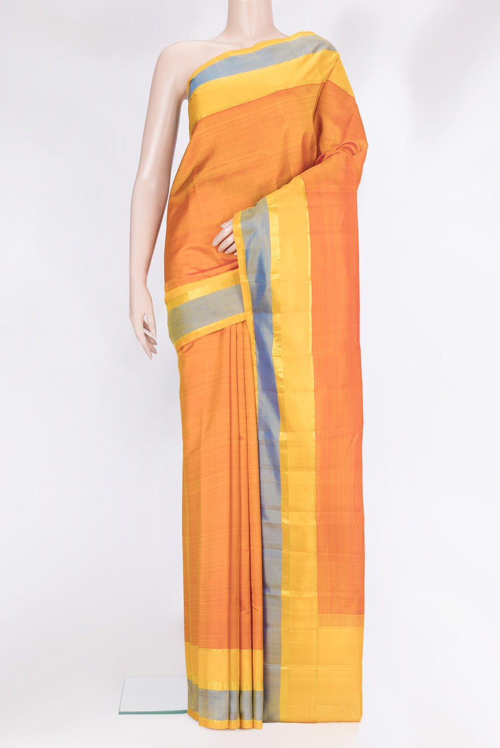 Rust Kanjivaram Silk Saree with Plain Body and Zari Border.  displayed on a mannequin